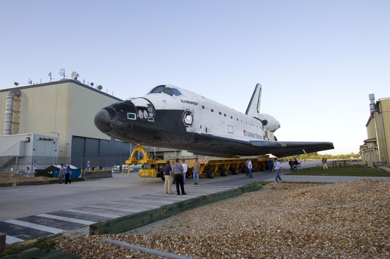 CAPE CANAVERAL, Fla. -- At NASA's Kennedy Space Center in Florida, workers accompany space shuttle Endeavour as it is being transported from Orbiter Processing Facility-2 to the Vehicle Assembly Building. Endeavour and its STS-134 crew will deliver the Express Logistics Carrier-3, Alpha Magnetic Spectrometer, spare parts, a high-pressure gas tank, additional spare parts for Dextre and micrometeoroid debris shields to the International Space Station. Launch is targeted for April 19 at 7:48 p.m. EDT. For more information visit, http://www.nasa.gov/mission_pages/shuttle/shuttlemissions/sts134/index.html. Photo credit: NASA/Jack Pfaller