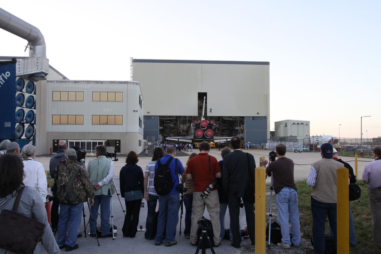 CAPE CANAVERAL, Fla. -- At NASA's Kennedy Space Center in Florida, media gather outside of Orbiter Processing Facility-2 to photograph space shuttle Endeavour's move, or "rollover," to the Vehicle Assembly Building (VAB). In the VAB, Endeavour will be lifted into a high bay where it will be attached to its external fuel tank and solid rocket boosters for its final and upcoming STS-134 mission.              Endeavour and its STS-134 crew will deliver the Express Logistics Carrier-3, Alpha Magnetic Spectrometer, spare parts, a high-pressure gas tank, additional spare parts for Dextre and micrometeoroid debris shields to the International Space Station. Launch is targeted for April 19 at 7:48 p.m. EDT. For more information visit, http://www.nasa.gov/mission_pages/shuttle/shuttlemissions/sts134/index.html. Photo credit: NASA