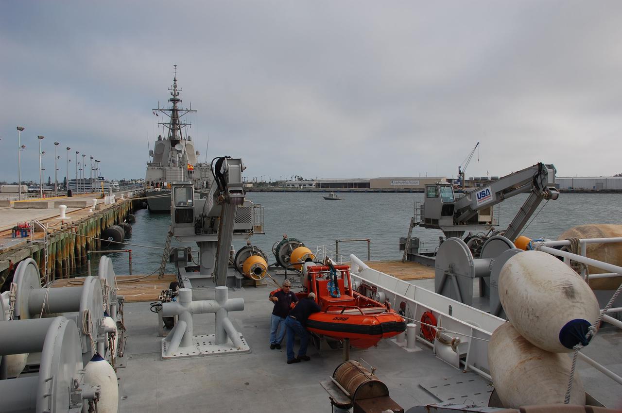 CAPE CANAVERAL, Fla. -- Workers on the deck of Freedom Star, one of NASA's solid rocket booster retrieval ships docked at Port Canaveral, Florida, prepare the vessel prior to sailing. Freedom Star will be in position to recover the spent boosters after space shuttle Discovery's STS-133 launch.      The shuttle’s two solid rocket booster casings and associated flight hardware are recovered in the Atlantic Ocean after every launch by Liberty Star and Freedom Star. The boosters impact the Atlantic about seven minutes after liftoff and the retrieval ships are stationed about 10 miles from the impact area at the time of splashdown. After the spent segments are processed, they will be transported to Utah, where they will be refurbished and stored, if needed. Photo credit: NASA/Ben Smegelsky