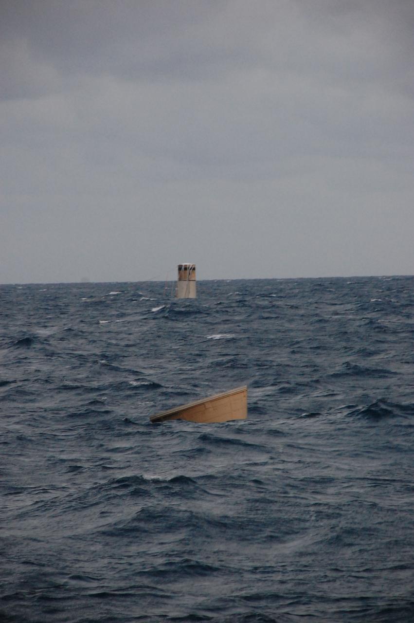 CAPE CANAVERAL, Fla. -- The nose cap and the top of a spent booster can be seen bobbing in the Atlantic Ocean, waiting to be recovered by the crew members of Freedom Star, one of NASA's solid rocket booster retrieval ships.       The shuttle’s two solid rocket booster casings and associated flight hardware are recovered in the Atlantic Ocean after every launch by Liberty Star and Freedom Star. The boosters impact the Atlantic about seven minutes after liftoff and the retrieval ships are stationed about 10 miles from the impact area at the time of splashdown. After the spent segments are processed, they will be transported to Utah, where they will be refurbished and stored, if needed. Photo credit: NASA/Ben Smegelsky