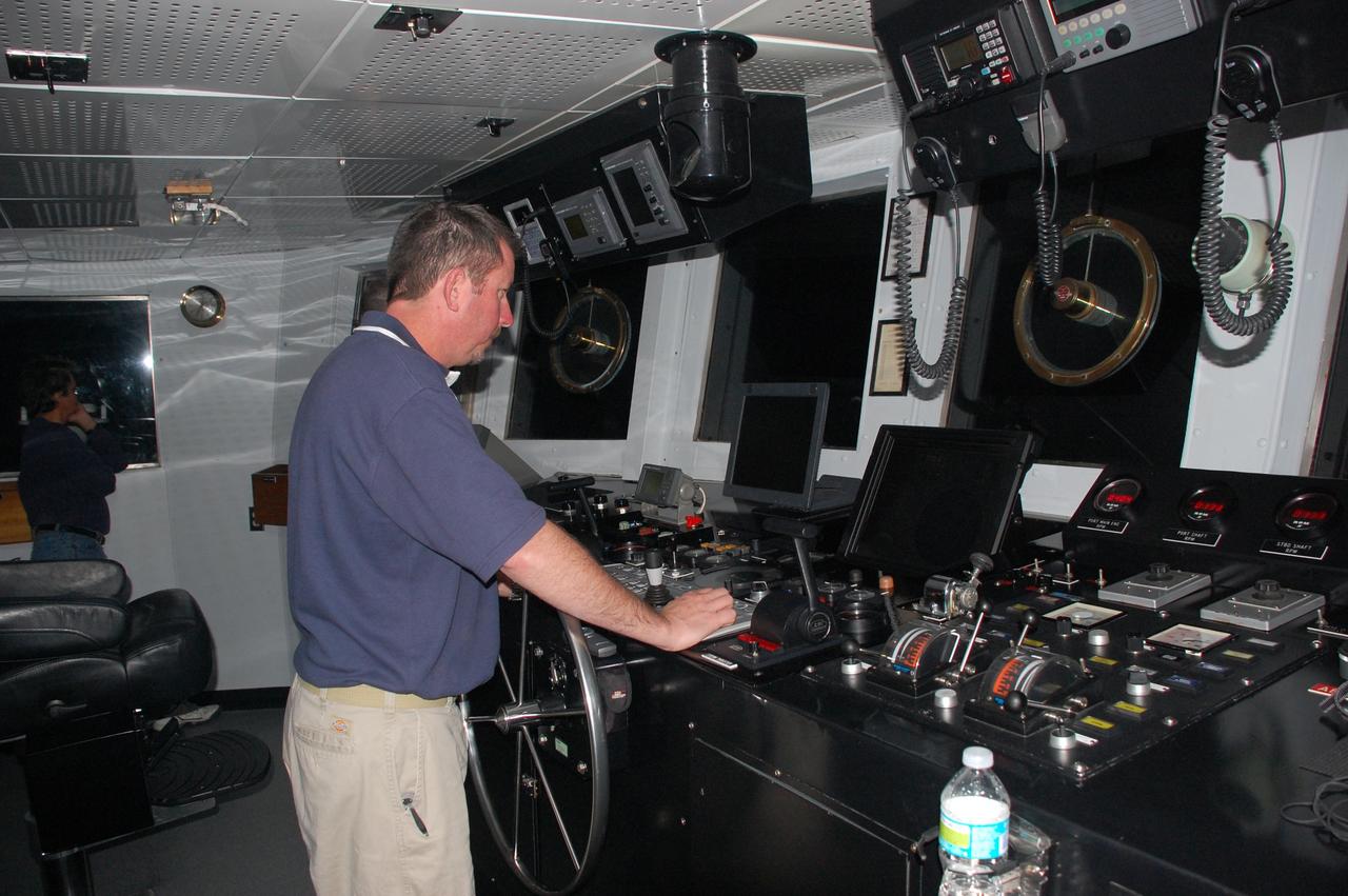 CAPE CANAVERAL, Fla. -- Chief Mate Jamie Harris is steering Freedom Star, one of NASA's solid rocket booster retrieval ships in the direction of the left spent booster that splashed down into the Atlantic Ocean after space shuttle Discovery's STS-133 launch.    The shuttle’s two solid rocket booster casings and associated flight hardware are recovered in the Atlantic Ocean after every launch by Liberty Star and Freedom Star. The boosters impact the Atlantic about seven minutes after liftoff and the retrieval ships are stationed about 10 miles from the impact area at the time of splashdown. After the spent segments are processed, they will be transported to Utah, where they will be refurbished and stored, if needed. Photo credit: NASA/Ben Smegelsky