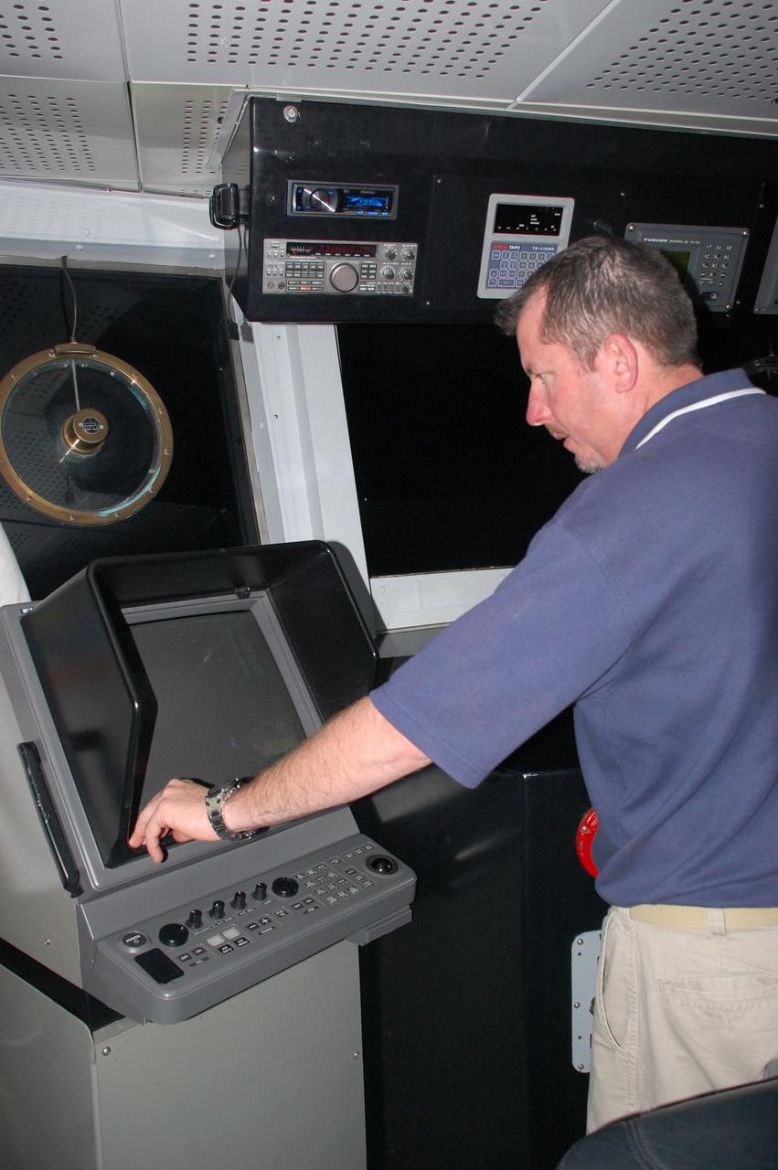 CAPE CANAVERAL, Fla. -- Chief Mate Jamie Harris is steering Freedom Star, one of NASA's solid rocket booster retrieval ships in the direction of the left spent booster that splashed down into the Atlantic Ocean after space shuttle Discovery's STS-133 launch.            The shuttle’s two solid rocket booster casings and associated flight hardware are recovered in the Atlantic Ocean after every launch by Liberty Star and Freedom Star. The boosters impact the Atlantic about seven minutes after liftoff and the retrieval ships are stationed about 10 miles from the impact area at the time of splashdown. After the spent segments are processed, they will be transported to Utah, where they will be refurbished and stored, if needed. Photo credit: NASA/Ben Smegelsky
