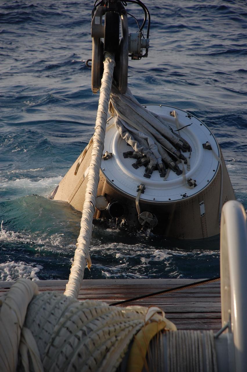 CAPE CANAVERAL, Fla. -- A crane on Freedom Star, one of NASA's solid rocket booster retrieval ships, heaves the left spent booster nose cap from the Atlantic Ocean and onto the deck after space shuttle Discovery's STS-133 launch.        The shuttle’s two solid rocket booster casings and associated flight hardware are recovered in the Atlantic Ocean after every launch by Liberty Star and Freedom Star. The boosters impact the Atlantic about seven minutes after liftoff and the retrieval ships are stationed about 10 miles from the impact area at the time of splashdown. After the spent segments are processed, they will be transported to Utah, where they will be refurbished and stored, if needed. Photo credit: NASA/Ben Smegelsky
