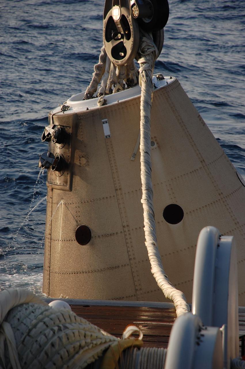 CAPE CANAVERAL, Fla. -- A crane on Freedom Star, one of NASA's solid rocket booster retrieval ships, heaves the left spent booster nose cap from the Atlantic Ocean and onto the deck after space shuttle Discovery's STS-133 launch.        The shuttle’s two solid rocket booster casings and associated flight hardware are recovered in the Atlantic Ocean after every launch by Liberty Star and Freedom Star. The boosters impact the Atlantic about seven minutes after liftoff and the retrieval ships are stationed about 10 miles from the impact area at the time of splashdown. After the spent segments are processed, they will be transported to Utah, where they will be refurbished and stored, if needed. Photo credit: NASA/Ben Smegelsky