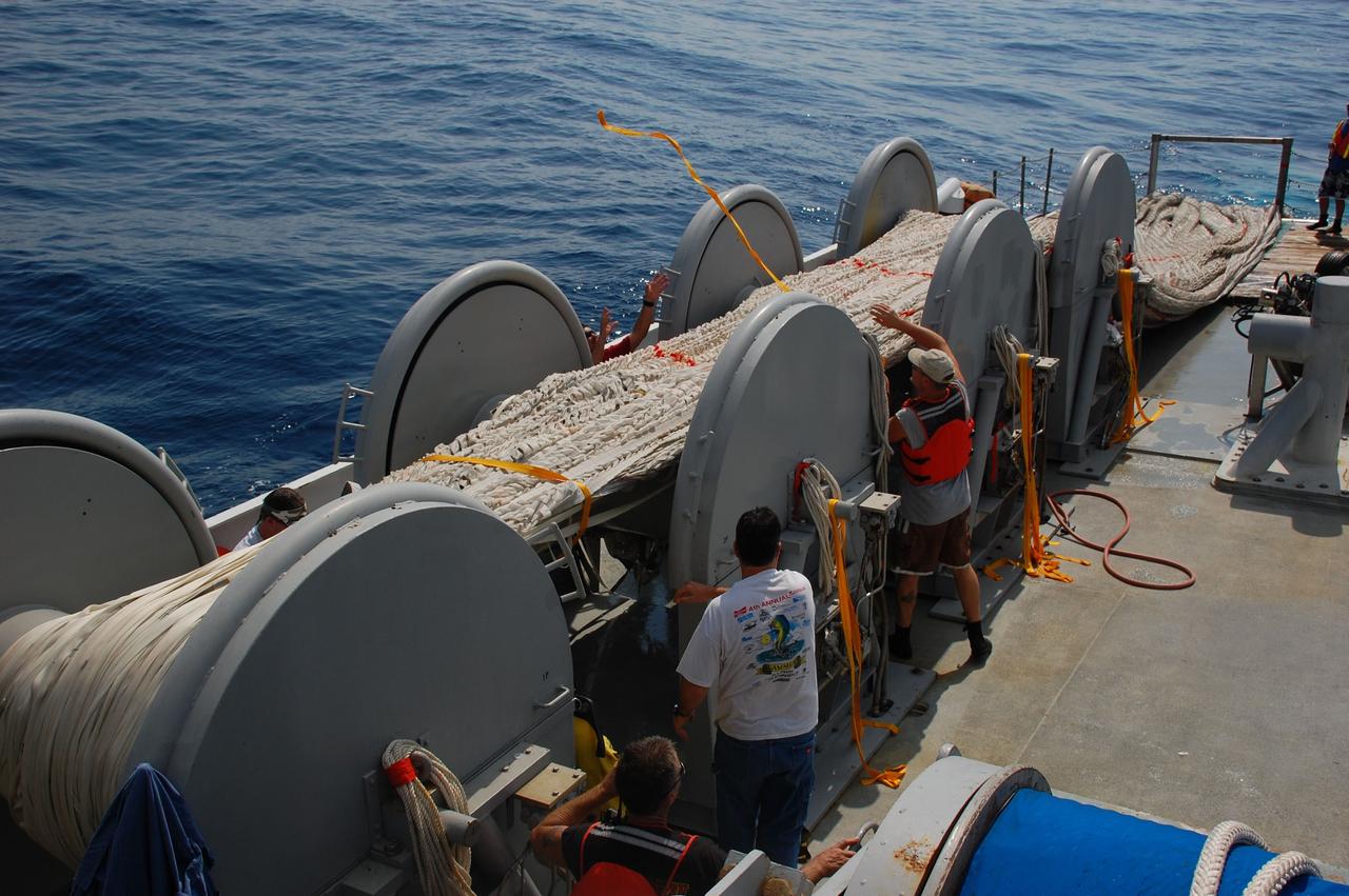CAPE CANAVERAL, Fla. -- Crew members from Freedom Star, one of NASA's solid rocket booster retrieval ships, are pulling the parachute from the left spent booster out of the Atlantic Ocean.            The shuttle’s two solid rocket booster casings and associated flight hardware are recovered in the Atlantic Ocean after every launch by Liberty Star and Freedom Star. The boosters impact the Atlantic about seven minutes after liftoff and the retrieval ships are stationed about 10 miles from the impact area at the time of splashdown. After the spent segments are processed, they will be transported to Utah, where they will be refurbished and stored, if needed. Photo credit: NASA/Ben Smegelsky