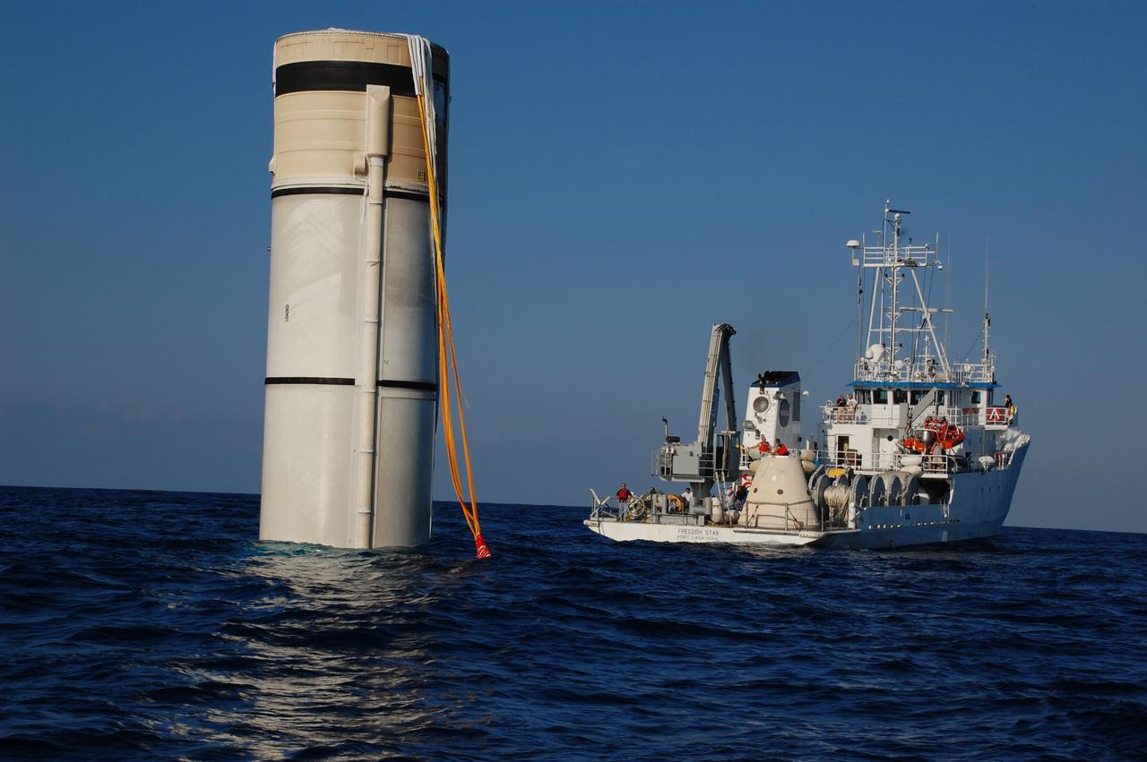 CAPE CANAVERAL, Fla. -- The left spent booster from space shuttle Discovery's final launch is seen bobbing in the Atlantic Ocean as air is pumped into it to lift it out of the water so it can float horizontally for towing back to Port Canaveral, Florida by Freedom Star, one of NASA's solid rocket booster retrieval ships.          The shuttle’s two solid rocket booster casings and associated flight hardware are recovered in the Atlantic Ocean after every launch by Liberty Star and Freedom Star. The boosters impact the Atlantic about seven minutes after liftoff and the retrieval ships are stationed about 10 miles from the impact area at the time of splashdown. After the spent segments are processed, they will be transported to Utah, where they will be refurbished and stored, if needed. Photo credit: NASA/Ben Smegelsky