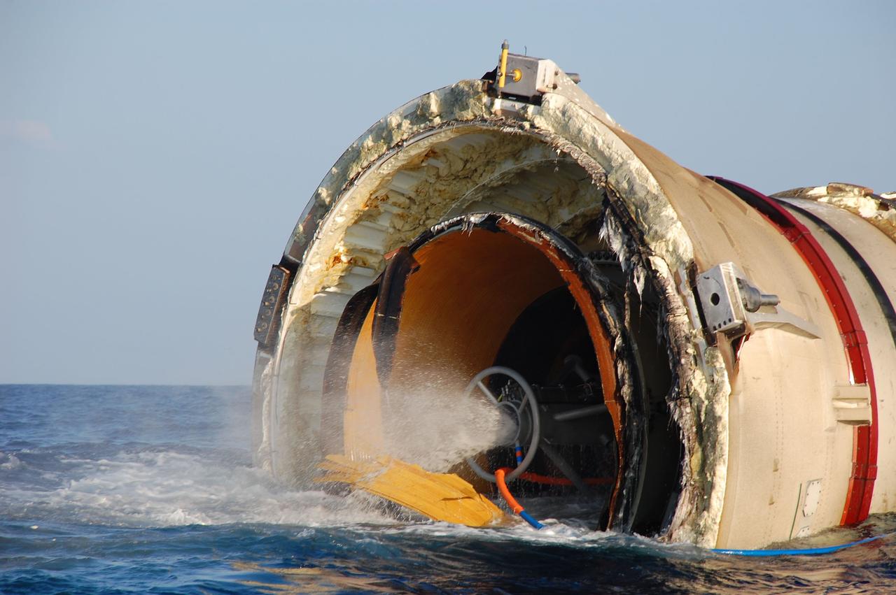CAPE CANAVERAL, Fla. -- The left spent booster from space shuttle Discovery's final launch is seen floating on the water's surface while pumps on Freedom Star, one of NASA's solid rocket booster retrieval ships, push debris and water out of the booster, replacing with air to facilitate floating for its return to Port Canaveral in Florida.                The shuttle’s two solid rocket booster casings and associated flight hardware are recovered in the Atlantic Ocean after every launch by Liberty Star and Freedom Star. The boosters impact the Atlantic about seven minutes after liftoff and the retrieval ships are stationed about 10 miles from the impact area at the time of splashdown. After the spent segments are processed, they will be transported to Utah, where they will be refurbished and stored, if needed. Photo credit: NASA/Ben Smegelsky
