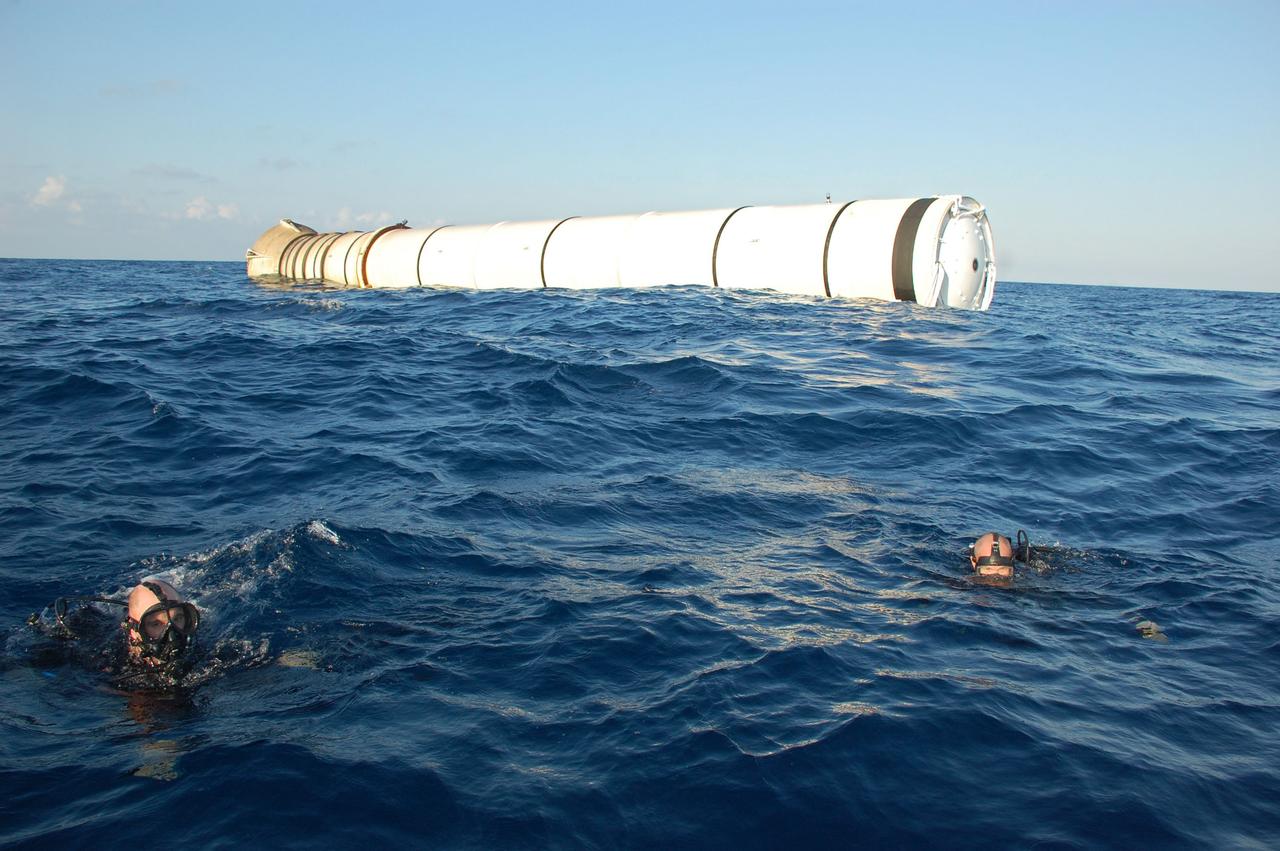 CAPE CANAVERAL, Fla. -- Divers from Freedom Star, one of NASA's solid rocket booster retrieval ships, help with the recovery of the left spent booster from space shuttle Discovery's final launch, which will be hauled alongside the vessel and towed back to Port Canaveral in Florida.              The shuttle’s two solid rocket booster casings and associated flight hardware are recovered in the Atlantic Ocean after every launch by Liberty Star and Freedom Star. The boosters impact the Atlantic about seven minutes after liftoff and the retrieval ships are stationed about 10 miles from the impact area at the time of splashdown. After the spent segments are processed, they will be transported to Utah, where they will be refurbished and stored, if needed. Photo credit: NASA/Ben Smegelsky