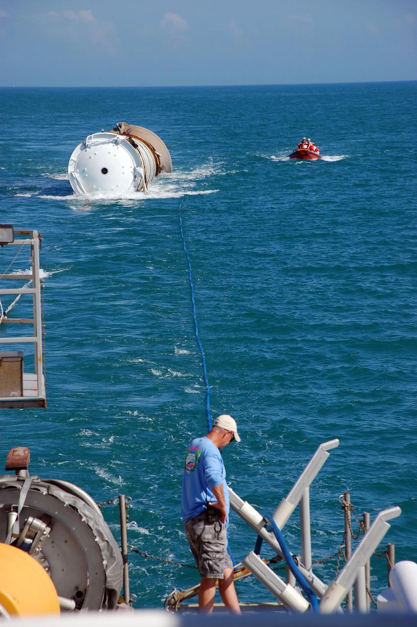 CAPE CANAVERAL, Fla. -- Crew members from Freedom Star, one of NASA's solid rocket booster retrieval ships, monitor the progress of the left spent booster from space shuttle Discovery's final launch, as it is towed toward the vessel for its return trip to Port Canaveral in Florida.            The shuttle’s two solid rocket booster casings and associated flight hardware are recovered in the Atlantic Ocean after every launch by Liberty Star and Freedom Star. The boosters impact the Atlantic about seven minutes after liftoff and the retrieval ships are stationed about 10 miles from the impact area at the time of splashdown. After the spent segments are processed, they will be transported to Utah, where they will be refurbished and stored, if needed. Photo credit: NASA/Ben Smegelsky