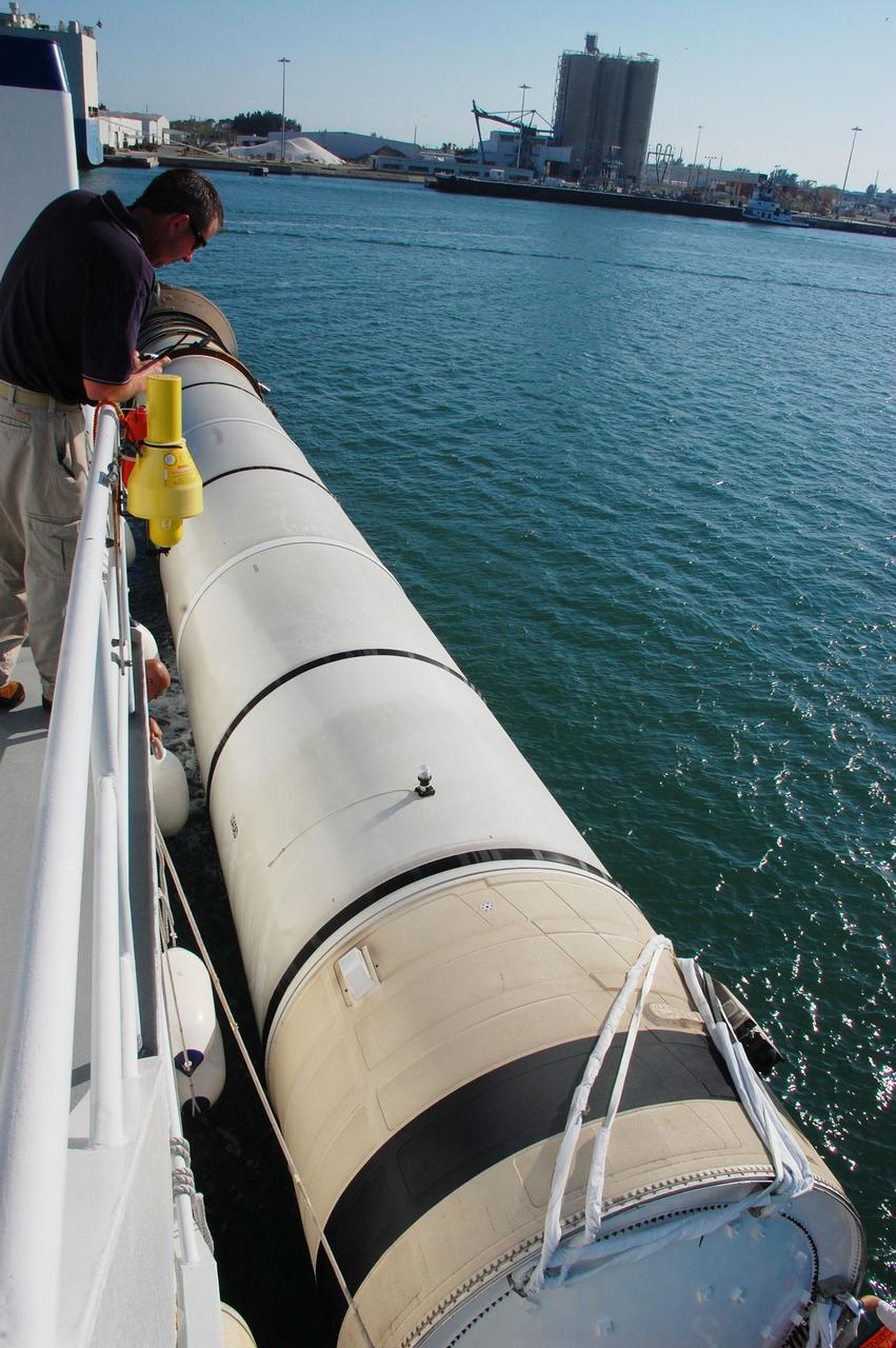 CAPE CANAVERAL, Fla. -- Jamie Harris Chief Mate for Freedom Star, one of NASA's solid rocket booster retrieval ships, checks the securing of the left spent booster from space shuttle Discovery's final launch, to the vessel, before continuing on the Hangar AF at Cape Canaveral Air Force Station.    The shuttle’s two solid rocket booster casings and associated flight hardware are recovered in the Atlantic Ocean after every launch by Liberty Star and Freedom Star. The boosters impact the Atlantic about seven minutes after liftoff and the retrieval ships are stationed about 10 miles from the impact area at the time of splashdown. After the spent segments are processed, they will be transported to Utah, where they will be refurbished and stored, if needed. Photo credit: NASA/Ben Smegelsky