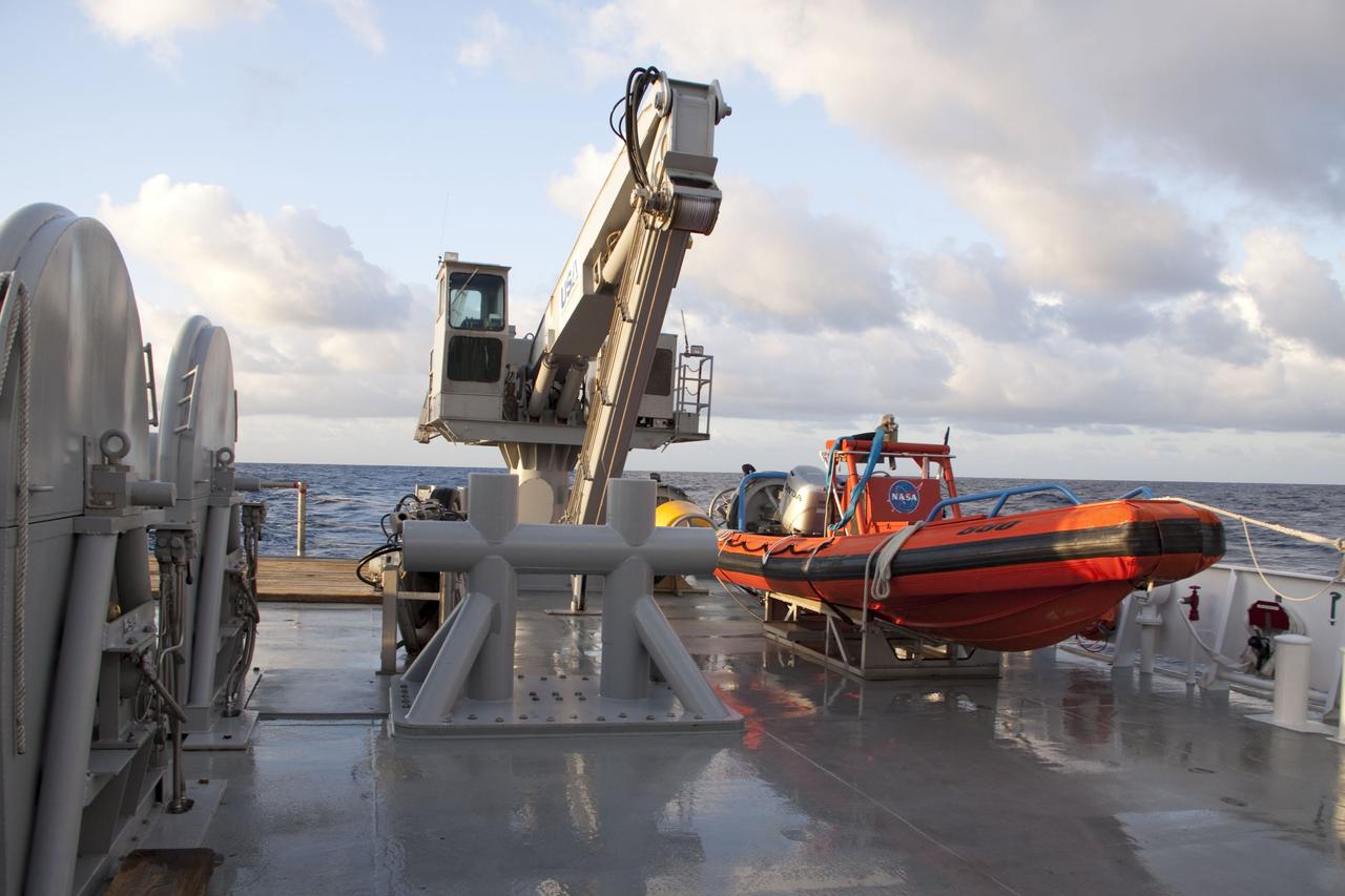 CAPE CANAVERAL, Fla. -- A crane and a skiff await Liberty Star, one of NASA's solid rocket booster retrieval ships, to reach the splash-down area where the right spent booster from Discovery's final launch has landed.          The shuttle’s two solid rocket booster casings and associated flight hardware are recovered in the Atlantic Ocean after every launch by Liberty Star and Liberty Star. The boosters impact the Atlantic about seven minutes after liftoff and the retrieval ships are stationed about 10 miles from the impact area at the time of splashdown. After the spent segments are processed, they will be transported to Utah, where they will be refurbished and stored, if needed. Photo credit: NASA/Frank Michaux