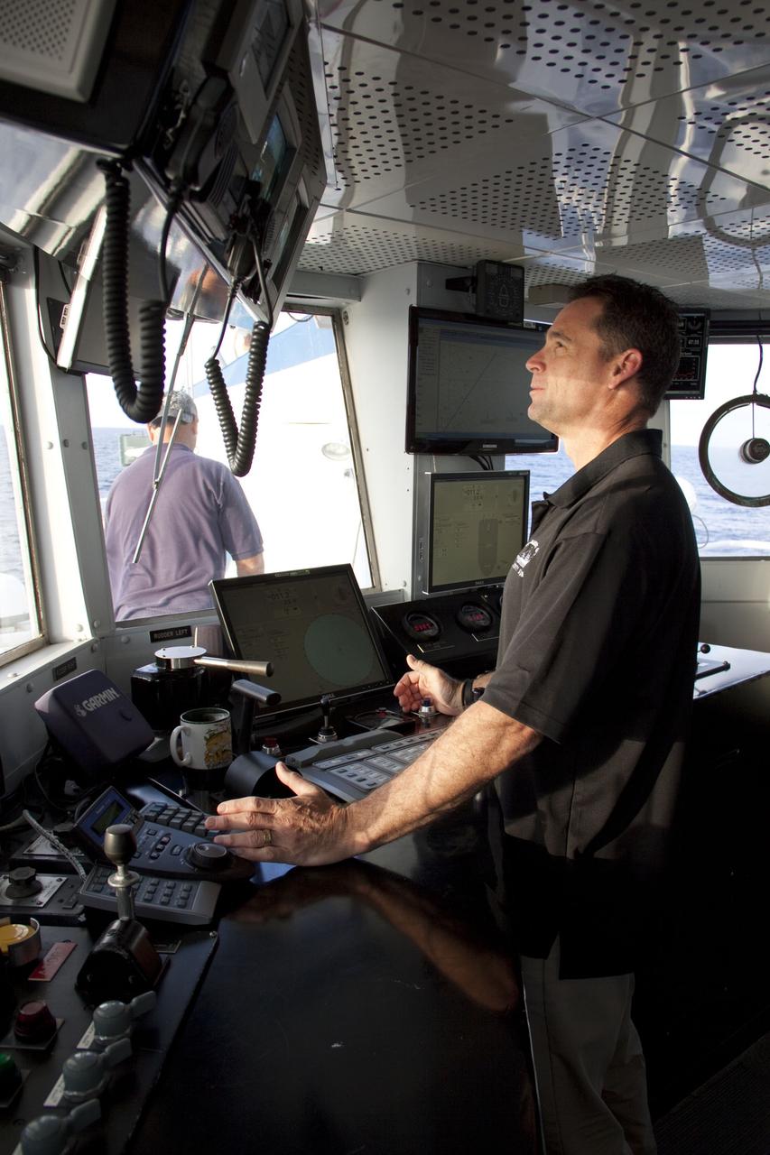CAPE CANAVERAL, Fla. -- Captain Bren Wade is steering Liberty Star, one of NASA's solid rocket booster retrieval ships in the direction of the right spent booster that splashed down into the Atlantic Ocean after space shuttle Discovery's STS-133 launch.        The shuttle’s two solid rocket booster casings and associated flight hardware are recovered in the Atlantic Ocean after every launch by Freedom Star and Liberty Star. The boosters impact the Atlantic about seven minutes after liftoff and the retrieval ships are stationed about 10 miles from the impact area at the time of splashdown. After the spent segments are processed, they will be transported to Utah, where they will be refurbished and stored, if needed. Photo credit: NASA/Frank Michaux