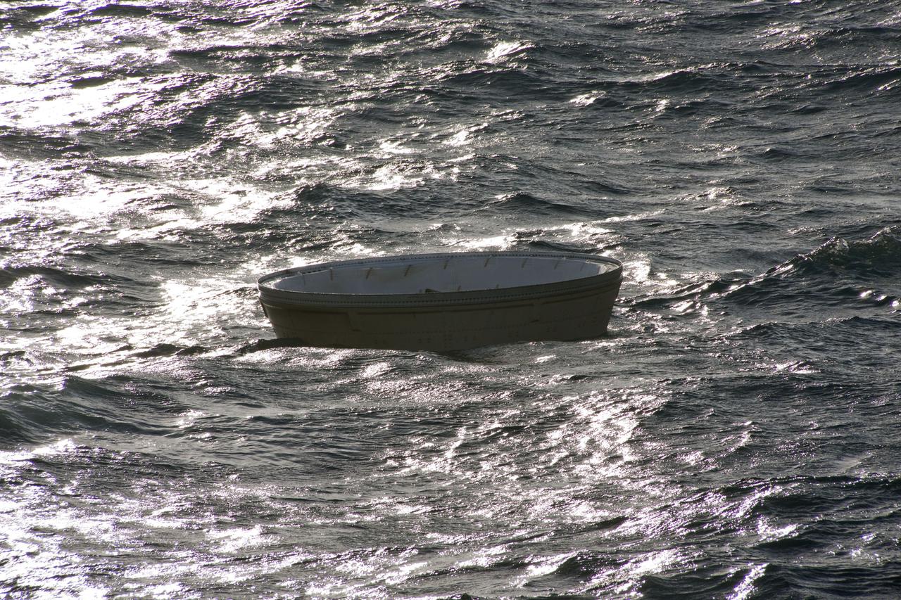 CAPE CANAVERAL, Fla. -- A nose cap from the right spent booster can be seen bobbing in the Atlantic Ocean, waiting to be recovered by the crew members of Liberty Star, one of NASA's solid rocket booster retrieval ships.          The shuttle’s two solid rocket booster casings and associated flight hardware are recovered in the Atlantic Ocean after every launch by Freedom Star and Liberty Star. The boosters impact the Atlantic about seven minutes after liftoff and the retrieval ships are stationed about 10 miles from the impact area at the time of splashdown. After the spent segments are processed, they will be transported to Utah, where they will be refurbished and stored, if needed. Photo credit: NASA/Frank Michaux