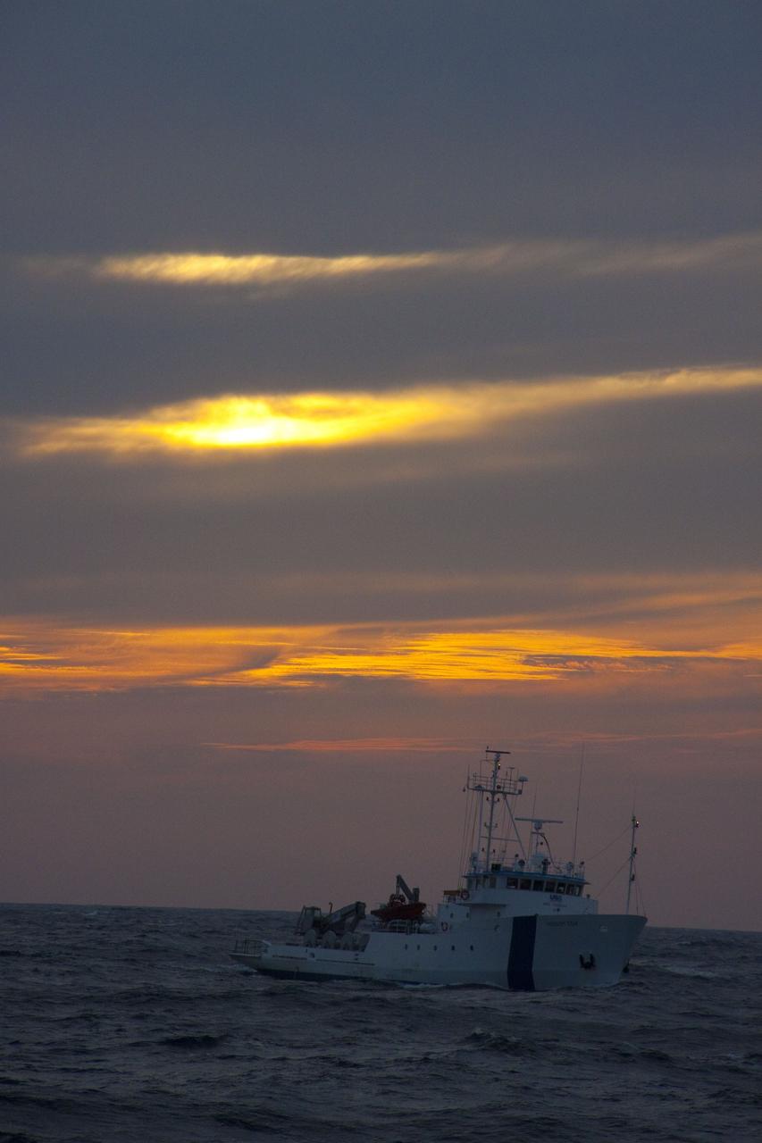 CAPE CANAVERAL, Fla. -- Dusk descends on the Freedom Star, one of NASA's solid rocket booster retrieval ships stationed in the Atlantic Ocean, to recover the right spent booster after it splashed down following space shuttle Discovery's final launch.            The shuttle’s two solid rocket booster casings and associated flight hardware are recovered in the Atlantic Ocean after every launch by Freedom Star and Liberty Star. The boosters impact the Atlantic about seven minutes after liftoff and the retrieval ships are stationed about 10 miles from the impact area at the time of splashdown. After the spent segments are processed, they will be transported to Utah, where they will be refurbished and stored, if needed. Photo credit: NASA/Frank Michaux