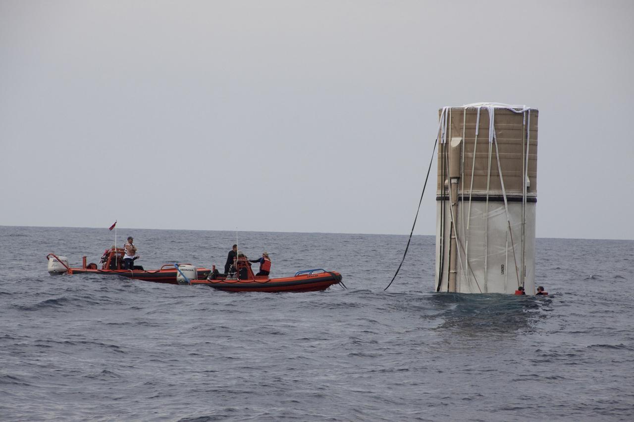 CAPE CANAVERAL, Fla. -- Crew members from Liberty Star, one of NASA's solid rocket booster retrieval ships, use skiffs to approach the right spent booster bobbing in the Atlantic Ocean after space shuttle Discovery's final launch. Divers are already in the water.                The shuttle's two solid rocket booster casings and associated flight hardware are recovered in the Atlantic Ocean after every launch by Freedom Star and Liberty Star. The boosters impact the Atlantic about seven minutes after liftoff and the retrieval ships are stationed about 10 miles from the impact area at the time of splashdown. After the spent segments are processed, they will be transported to Utah, where they will be refurbished and stored, if needed. Photo credit: NASA/Frank Michaux