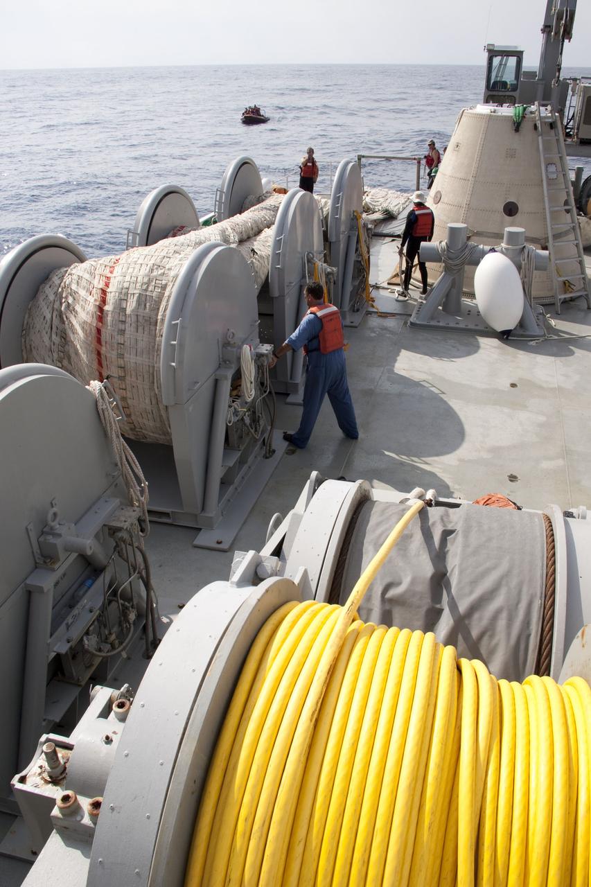 CAPE CANAVERAL, Fla. -- Crew members on board Liberty Star, one of NASA's solid rocket booster retrieval ships, haul in the massive parachute from the right spent booster from space shuttle Discovery's final launch.                          The shuttle's two solid rocket booster casings and associated flight hardware are recovered in the Atlantic Ocean after every launch by Freedom Star and Liberty Star. The boosters impact the Atlantic about seven minutes after liftoff and the retrieval ships are stationed about 10 miles from the impact area at the time of splashdown. After the spent segments are processed, they will be transported to Utah, where they will be refurbished and stored, if needed. Photo credit: NASA/Frank Michaux