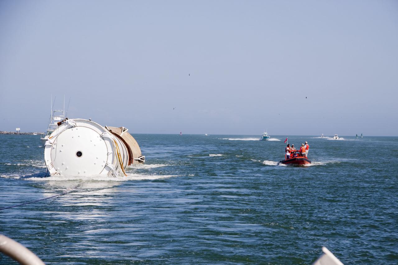 CAPE CANAVERAL, Fla. -- Liberty Star, one of NASA's solid rocket booster retrieval ships, tows the right spent booster from space shuttle Discovery's final launch, to Port Canaveral in Florida.                  The shuttle's two solid rocket booster casings and associated flight hardware are recovered in the Atlantic Ocean after every launch by Freedom Star and Liberty Star. The boosters impact the Atlantic about seven minutes after liftoff and the retrieval ships are stationed about 10 miles from the impact area at the time of splashdown. After the spent segments are processed, they will be transported to Utah, where they will be refurbished and stored, if needed. Photo credit: NASA/Frank Michaux