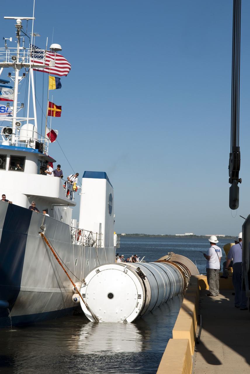 CAPE CANAVERAL, Fla. -- The Solid Rocket Booster Retrieval Ship Freedom Star tows a booster to the dock at Hangar AF on Cape Canaveral Air Force Station in Florida. The booster was used during space shuttle Discovery's STS-133 launch from NASA Kennedy Space Center's Launch Pad 39A on Feb. 24. The shuttle’s two solid rocket booster casings and associated flight hardware are recovered in the Atlantic Ocean after every launch by Liberty Star and Freedom Star.        The boosters impact the Atlantic about seven minutes after liftoff and the retrieval ships are stationed about 10 miles from the impact area at the time of splashdown.  After the spent segments are processed, they will be transported to Utah, where they will be refurbished and stored, if needed. Photo credit: NASA/Jim Grossmann
