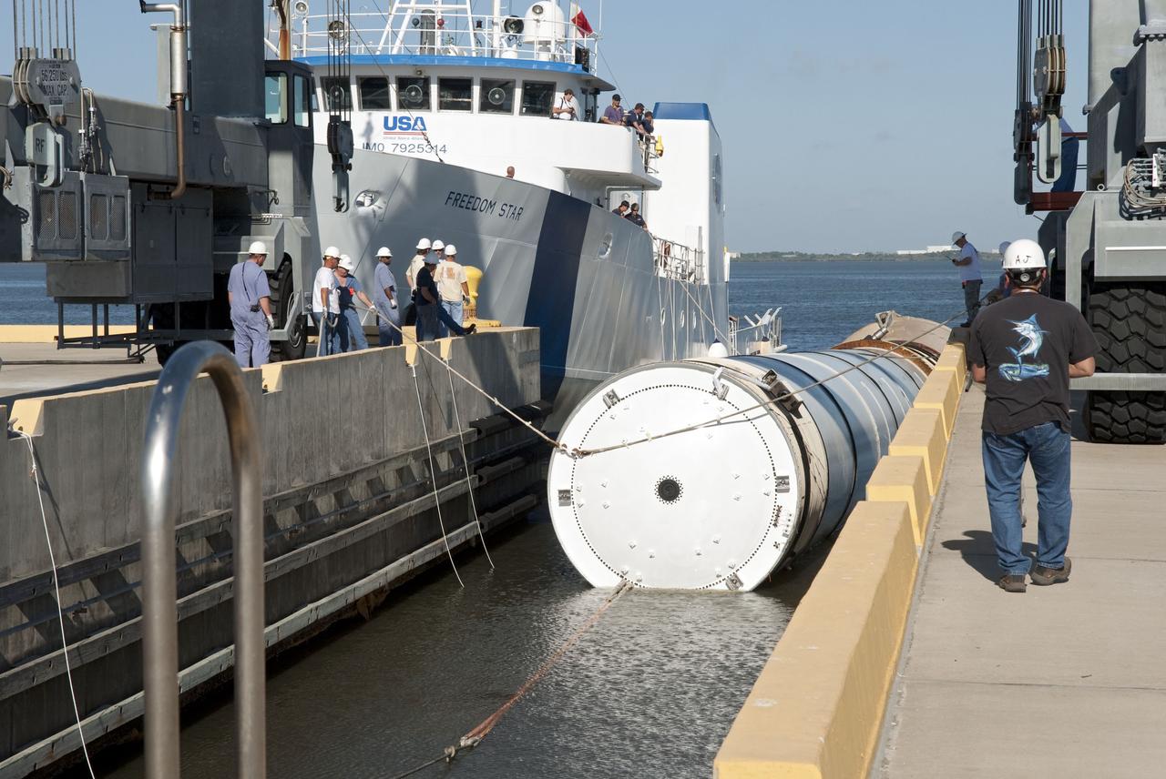 CAPE CANAVERAL, Fla. -- The Solid Rocket Booster Retrieval Ship Freedom Star towing a booster arrives to the dock at Hangar AF on Cape Canaveral Air Force Station in Florida. The booster was used during space shuttle Discovery's STS-133 launch from NASA Kennedy Space Center's Launch Pad 39A on Feb. 24. The shuttle’s two solid rocket booster casings and associated flight hardware are recovered in the Atlantic Ocean after every launch by Liberty Star and Freedom Star. The boosters impact the Atlantic about seven minutes after liftoff and the retrieval ships are stationed about 10 miles from the impact area at the time of splashdown. After the spent segments are processed, they will be transported to Utah, where they will be refurbished and stored, if needed. Photo credit: NASA/Jim Grossmann