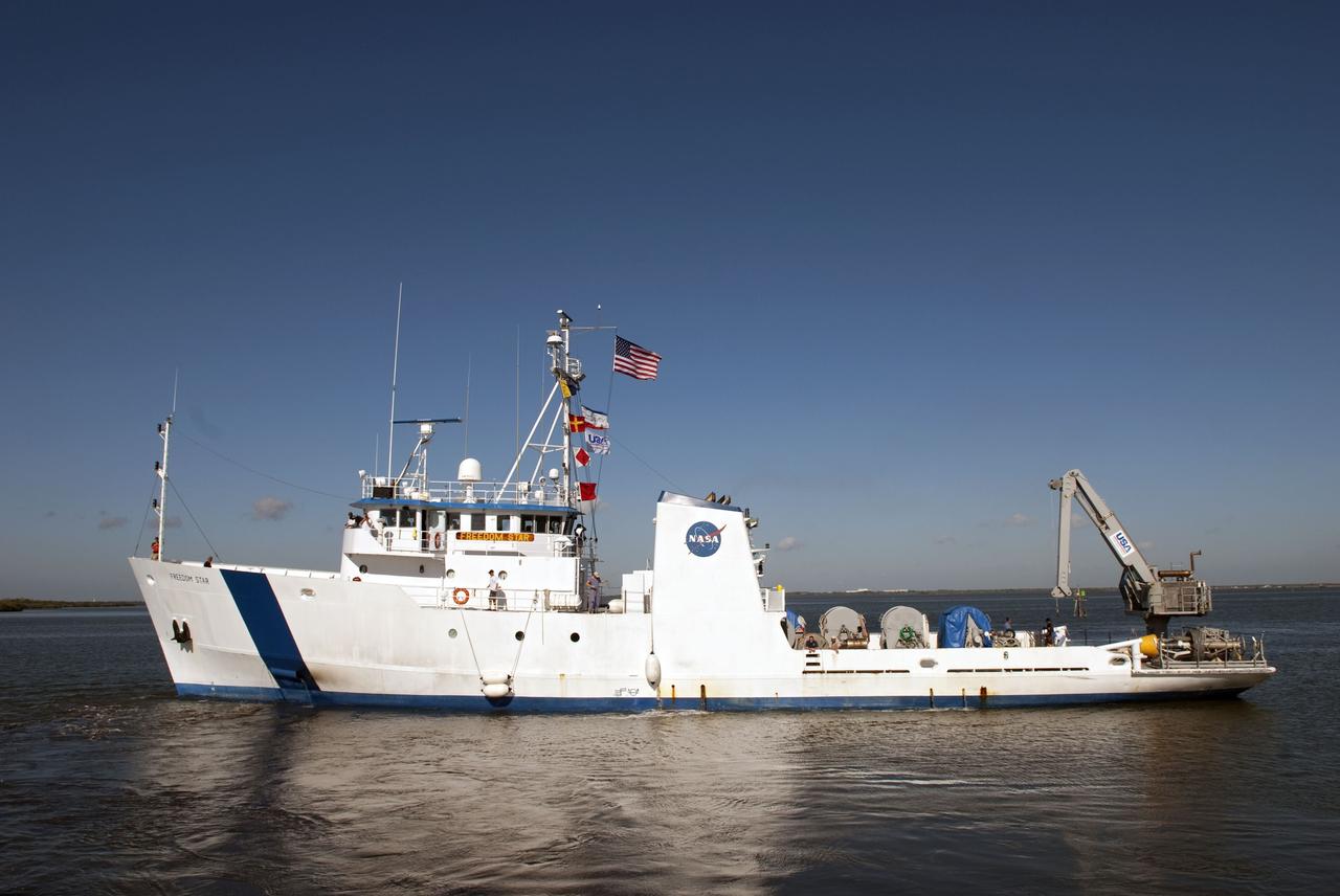 CAPE CANAVERAL, Fla. -- The Solid Rocket Booster Retrieval Ship Freedom Star leaves the dock at Hangar AF at Cape Canaveral Air Force Station and heads back to its home base at the Turn Basin at NASA's Kennedy Space Center in Florida. The ship recently retrieved a booster that was used during space shuttle Discovery's STS-133 launch from Kennedy's Launch Pad 39A on Feb. 24. The shuttle’s two solid rocket booster casings and associated flight hardware are recovered in the Atlantic Ocean after every launch by Liberty Star and Freedom Star.      The boosters impact the Atlantic about seven minutes after liftoff and the retrieval ships are stationed about 10 miles from the impact area at the time of splashdown.  After the spent segments are processed, they will be transported to Utah, where they will be refurbished and stored, if needed. Photo credit: NASA/Jim Grossmann