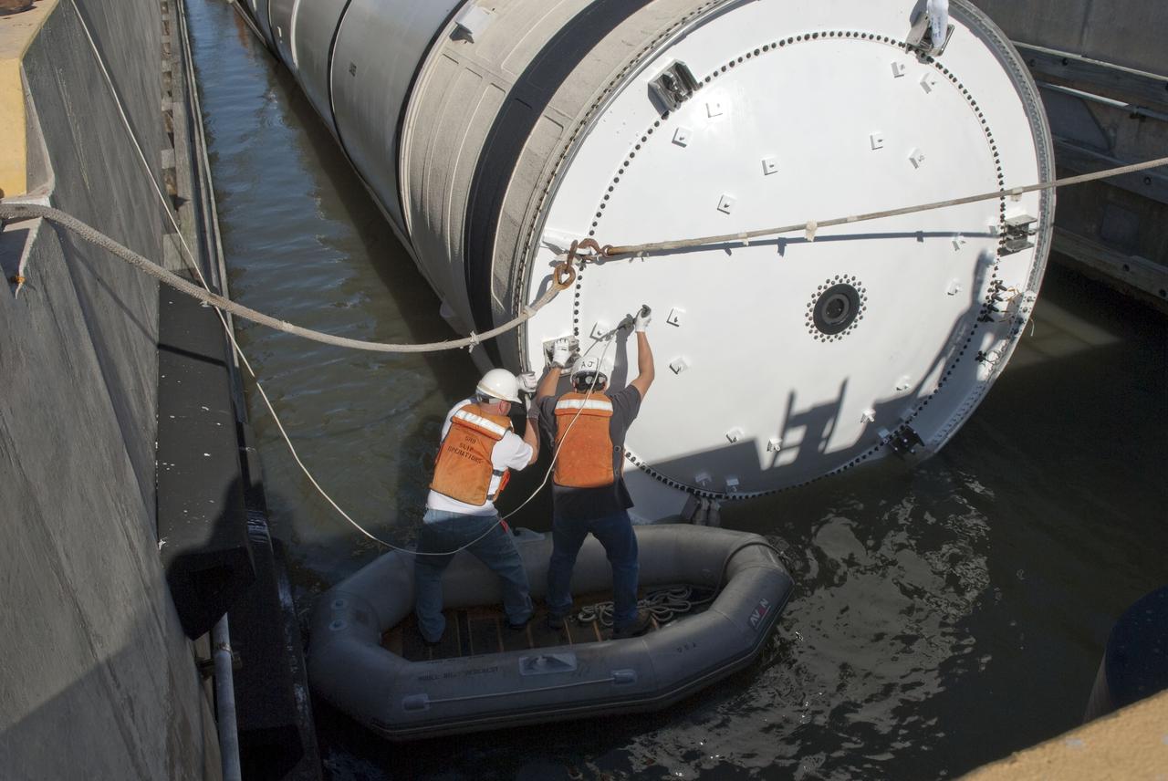 CAPE CANAVERAL, Fla. -- One of the solid rocket boosters used during space shuttle Discovery's STS-133 launch is unloaded onto a hoisting slip at the Solid Rocket Booster Disassembly Facility at Hangar AF on Cape Canaveral Air Force Station in Florida. Following the launch from NASA Kennedy Space Center's Launch Pad 39A on Feb. 24, the shuttle's two boosters fell into the Atlantic Ocean. There, the booster casings and associated flight hardware were recovered by Liberty Star and Freedom Star. The boosters impact the Atlantic about seven minutes after liftoff and the retrieval ships are stationed about 10 miles from the impact area at the time of splashdown. After the spent segments are processed, they will be transported to Utah, where they will be refurbished and stored, if needed. Photo credit: NASA/Jim Grossmann