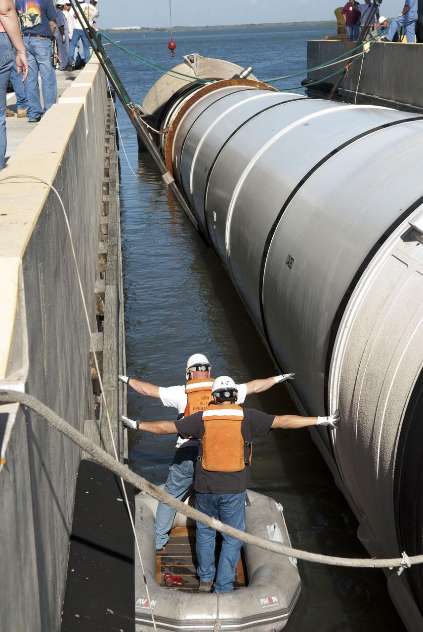CAPE CANAVERAL, Fla. -- One of the solid rocket boosters used during space shuttle Discovery's STS-133 launch is unloaded onto a hoisting slip at the Solid Rocket Booster Disassembly Facility at Hangar AF on Cape Canaveral Air Force Station in Florida. Following the launch from NASA Kennedy Space Center's Launch Pad 39A on Feb. 24, the shuttle's two boosters fell into the Atlantic Ocean. There, the booster casings and associated flight hardware were recovered by Liberty Star and Freedom Star. The boosters impact the Atlantic about seven minutes after liftoff and the retrieval ships are stationed about 10 miles from the impact area at the time of splashdown. After the spent segments are processed, they will be transported to Utah, where they will be refurbished and stored, if needed. Photo credit: NASA/Jim Grossmann