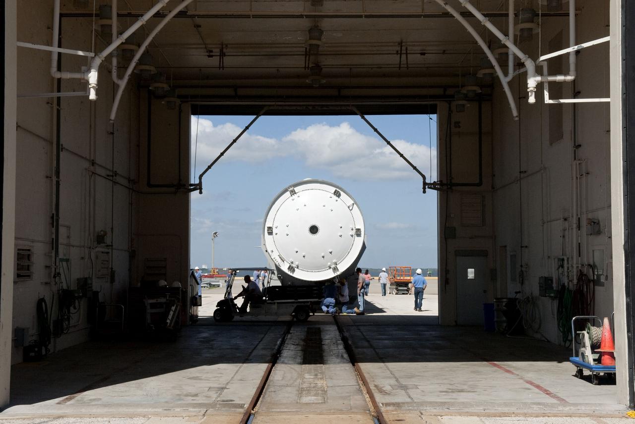 CAPE CANAVERAL, Fla. -- At the Solid Rocket Booster Disassembly Facility at Hangar AF on Cape Canaveral Air Force Station in Florida, one of the solid rocket boosters used during space shuttle Discovery's STS-133 launch is moved for processing atop a tracked dolly. Following the launch from NASA Kennedy Space Center's Launch Pad 39A on Feb. 24, the shuttle's two boosters fell into the Atlantic Ocean. There, the booster casings and associated flight hardware were recovered by Liberty Star and Freedom Star.      The boosters impact the Atlantic about seven minutes after liftoff and the retrieval ships are stationed about 10 miles from the impact area at the time of splashdown.  After the spent segments are processed, they will be transported to Utah, where they will be refurbished and stored, if needed. Photo credit: NASA/Jim Grossmann