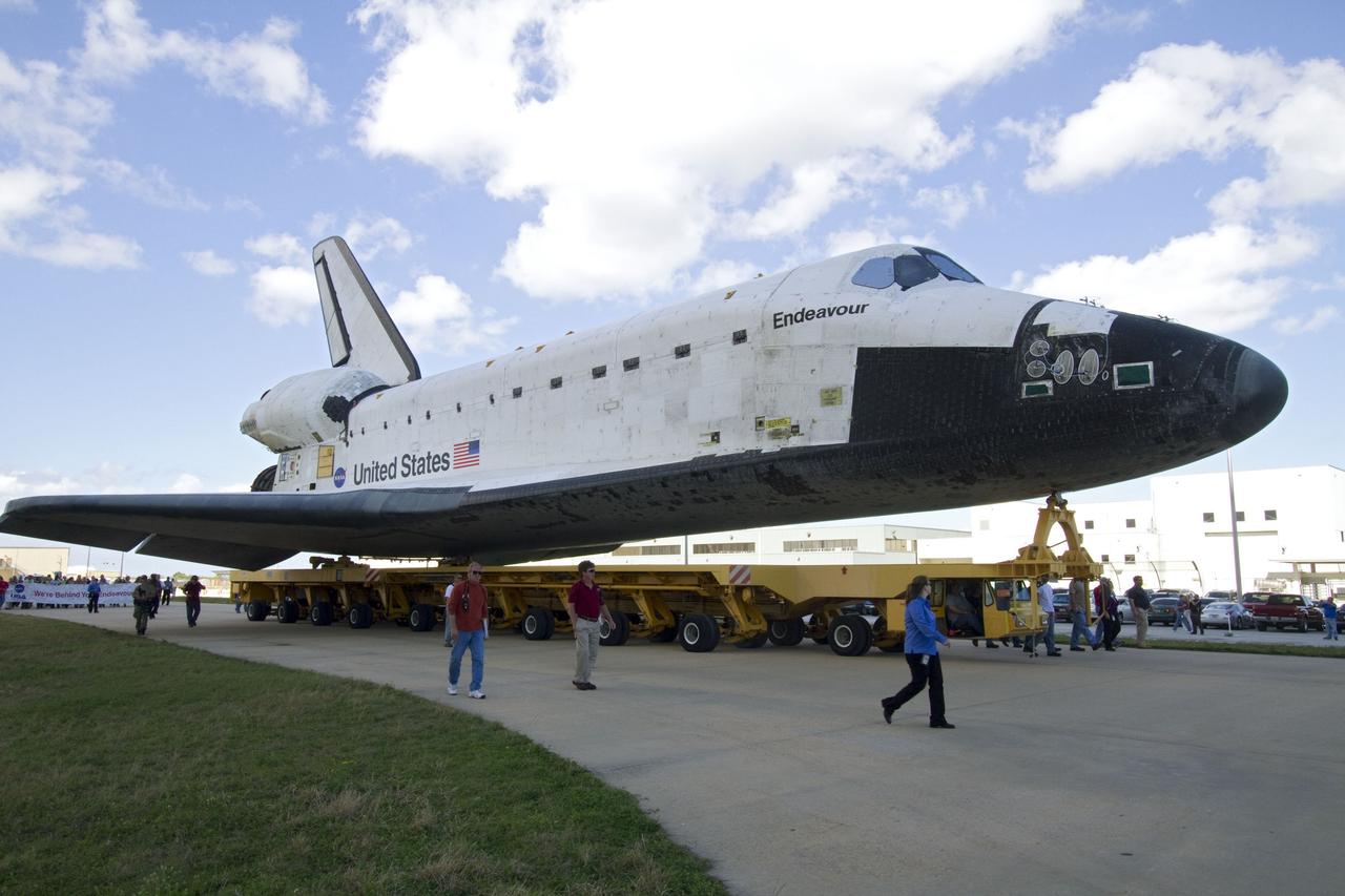 CAPE CANAVERAL, Fla. -- At NASA's Kennedy Space Center in Florida, workers accompany space shuttle Endeavour as it is being transported from Orbiter Processing Facility-2 to the Vehicle Assembly Building (VAB). In the VAB, Endeavour will be lifted into a high bay where it will be attached to its external fuel tank and solid rocket boosters for its final mission, STS-134.          Endeavour and its STS-134 crew will deliver the Express Logistics Carrier-3, Alpha Magnetic Spectrometer, a high-pressure gas tank, additional spare parts for Dextre and micrometeoroid debris shields to the International Space Station. Launch is targeted for April 19 at 7:48 p.m. EDT. For more information visit, http://www.nasa.gov/mission_pages/shuttle/shuttlemissions/sts134/index.html. Photo credit: NASA/Jack Pfaller