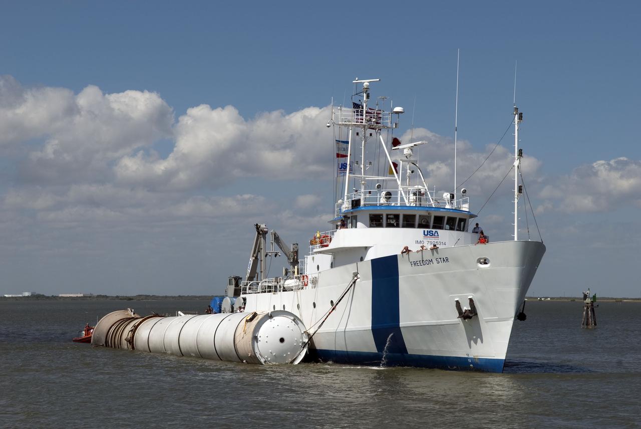 CAPE CANAVERAL, Fla. -- The solid rocket booster retrieval ship Freedom Star tows a left spent booster to the dock at Hangar AF on Cape Canaveral Air Force Station in Florida. The booster was used during space shuttle Discovery's final launch.                The shuttle's two solid rocket booster casings and associated flight hardware are recovered in the Atlantic Ocean after every launch by Freedom Star and Liberty Star. The boosters impact the Atlantic about seven minutes after liftoff and the retrieval ships are stationed about 10 miles from the impact area at the time of splashdown. After the spent segments are processed, they will be transported to Utah, where they will be refurbished and stored, if needed. Photo credit: NASA/Jim Grossmann