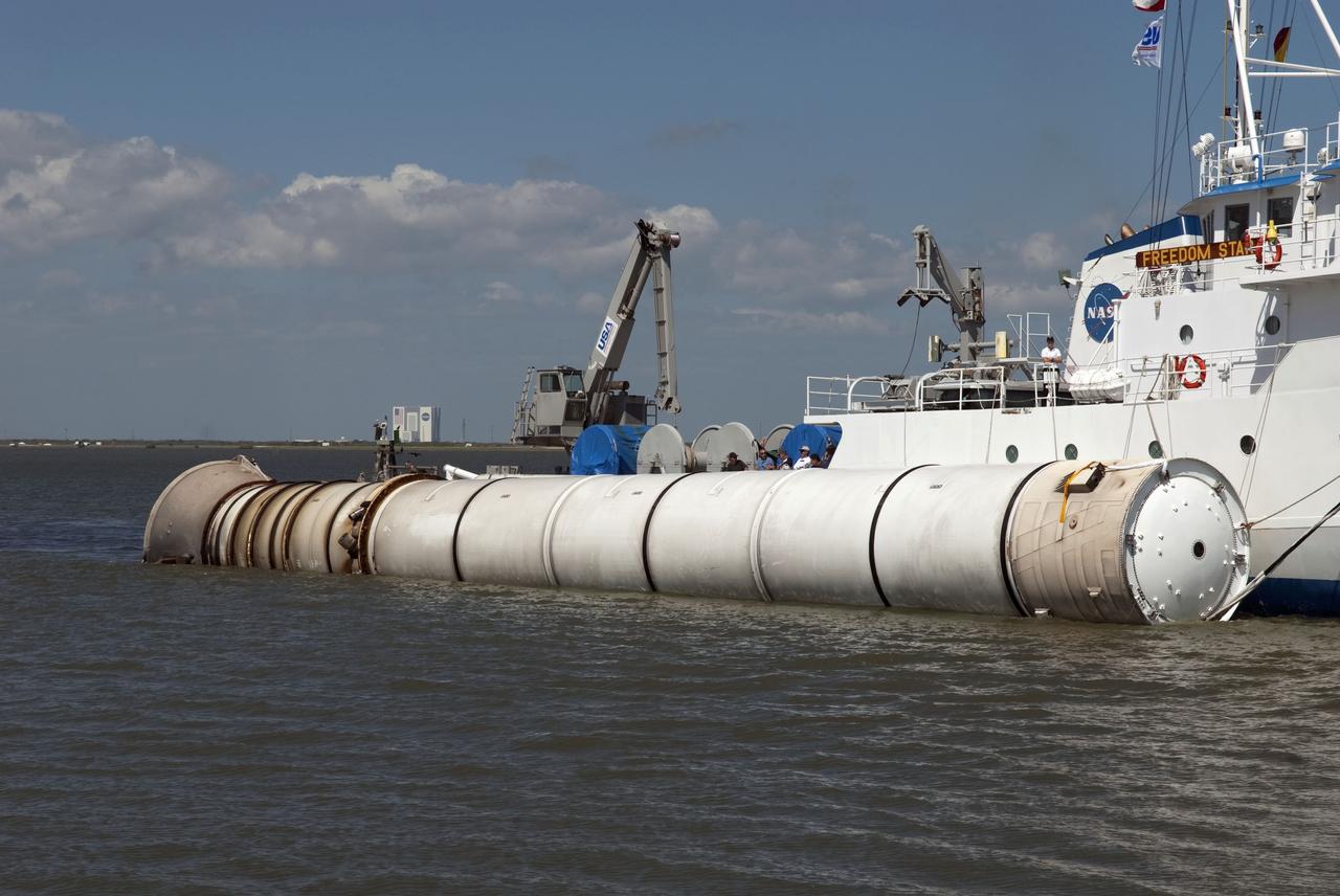 CAPE CANAVERAL, Fla. -- The solid rocket booster retrieval ship Freedom Star tows a left spent booster to the dock at Hangar AF on Cape Canaveral Air Force Station in Florida. The booster was used during space shuttle Discovery's final launch. The shuttle's two solid rocket booster casings and associated flight hardware are recovered in the Atlantic Ocean after every launch by Freedom Star and Liberty Star. The boosters impact the Atlantic about seven minutes after liftoff and the retrieval ships are stationed about 10 miles from the impact area at the time of splashdown. After the spent segments are processed, they will be transported to Utah, where they will be refurbished and stored, if needed. Photo credit: NASA/Jim Grossmann