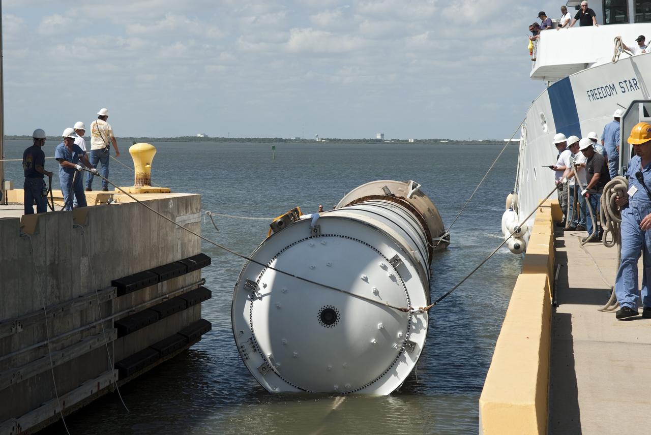 CAPE CANAVERAL, Fla. -- The left spent booster used during space shuttle Discovery's final launch is guided into a hoisting slip at the Solid Rocket Booster Disassembly Facility at Hangar AF on Cape Canaveral Air Force Station in Florida. The shuttle's two solid rocket booster casings and associated flight hardware are recovered in the Atlantic Ocean after every launch by Freedom Star and Liberty Star. The boosters impact the Atlantic about seven minutes after liftoff and the retrieval ships are stationed about 10 miles from the impact area at the time of splashdown. After the spent segments are processed, they will be transported to Utah, where they will be refurbished and stored, if needed. Photo credit: NASA/Jim Grossmann
