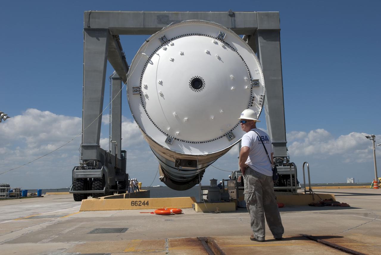 CAPE CANAVERAL, Fla. -- Workers at the hoisting slip at the Solid Rocket Booster Disassembly Facility at Hangar AF on Cape Canaveral Air Force Station in Florida, monitor the lifting of the left spent booster, used during space shuttle Discovery's final launch. The shuttle's two solid rocket booster casings and associated flight hardware are recovered in the Atlantic Ocean after every launch by Freedom Star and Liberty Star. The boosters impact the Atlantic about seven minutes after liftoff and the retrieval ships are stationed about 10 miles from the impact area at the time of splashdown. After the spent segments are processed, they will be transported to Utah, where they will be refurbished and stored, if needed. Photo credit: NASA/Jim Grossmann