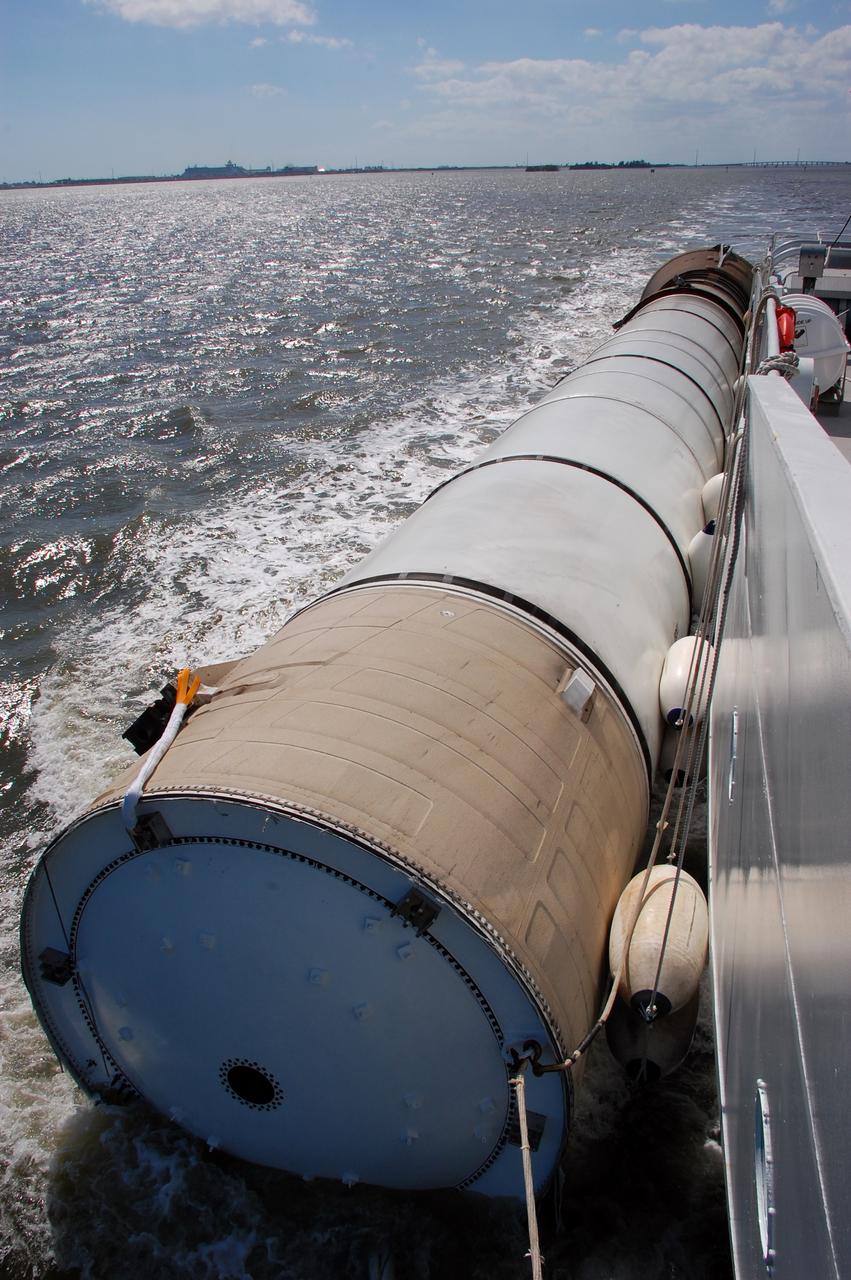 CAPE CANAVERAL, Fla. -- Liberty Star, one of NASA's solid rocket booster retrieval ships, ushers a spent shuttle booster to Hangar AF at Cape Canaveral Air Force Station in Florida. The booster was used during space shuttle Discovery's STS-133 launch from NASA Kennedy Space Center's Launch Pad 39A on Feb. 24. The shuttle’s two solid rocket booster casings and associated flight hardware are recovered in the Atlantic Ocean after every launch by Freedom Star and Liberty Star. The boosters impact the Atlantic about seven minutes after liftoff and the retrieval ships are stationed about 10 miles from the impact area at the time of splashdown.  After the spent segments are processed, they will be transported to Utah, where they will be refurbished and stored, if needed. Photo credit: NASA/Ben Smegelsky