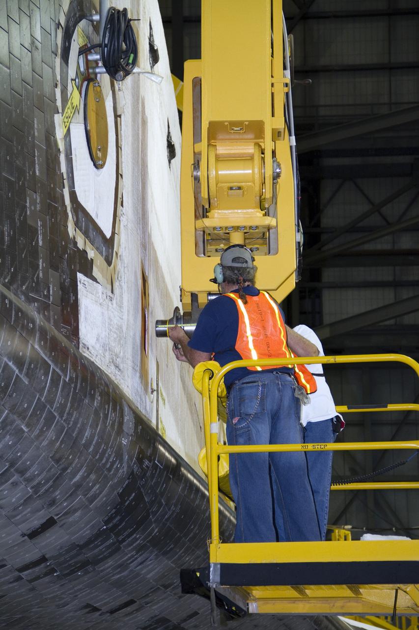 CAPE CANAVERAL, Fla. -- In the Vehicle Assembly Building at NASA's Kennedy Space Center in Florida, workers attach an overhead crane to shuttle Endeavour. The crane will lift the spacecraft into a high bay where it will be attached to the waiting external fuel tank and solid rocket boosters.              Endeavour and its STS-134 crew will deliver the Express Logistics Carrier-3, Alpha Magnetic Spectrometer, a high-pressure gas tank, additional spare parts for Dextre and micrometeoroid debris shields to the International Space Station. Endeavour's final launch is targeted for April 19 at 7:48 p.m. EDT. For more information visit, http://www.nasa.gov/mission_pages/shuttle/shuttlemissions/sts134/index.html. Photo credit: NASA/Jack Pfaller