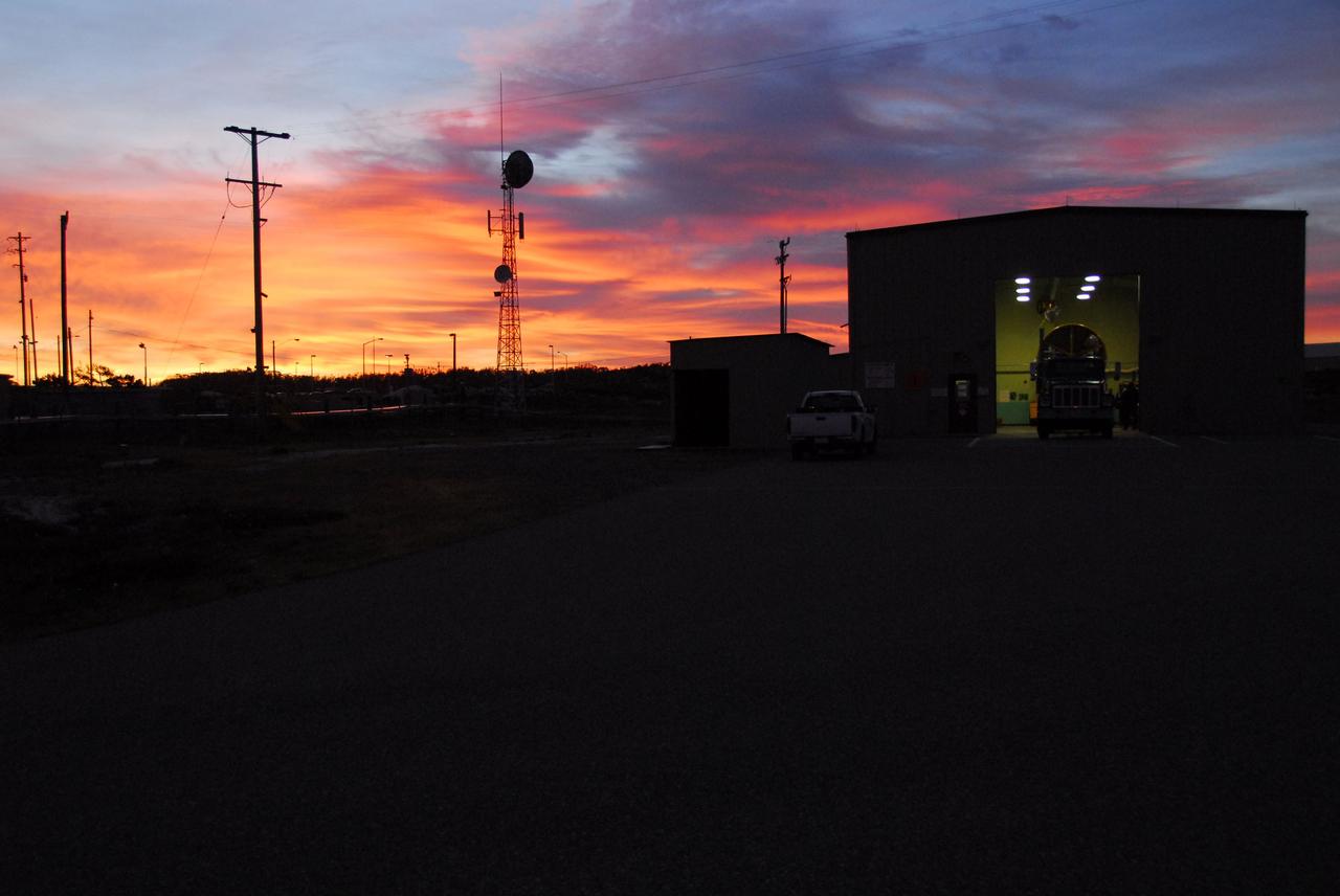 VANDENBERG AIR FORCE BASE, Calif. -- As the sun rises over Vandenberg Air Force Base in California, the first stage of the United Launch Alliance Delta II rocket that will carry the Aquarius/SAC-D satellite into low Earth orbit is prepared for its move to Space Launch Complex-2 (SLC-2).      Scheduled to launch in June, Aquarius' mission will be to provide monthly maps of global changes in sea surface salinity. By measuring ocean salinity from space, Aquarius will provide new insights into how the massive natural exchange of freshwater between the ocean, atmosphere and sea ice influences ocean circulation, weather and climate. Also going up with the satellite are optical and thermal cameras, a microwave radiometer and the SAC-D spacecraft, which were developed with the help of institutions in Italy, France, Canada and Argentina. Photo credit: NASA/VAFB