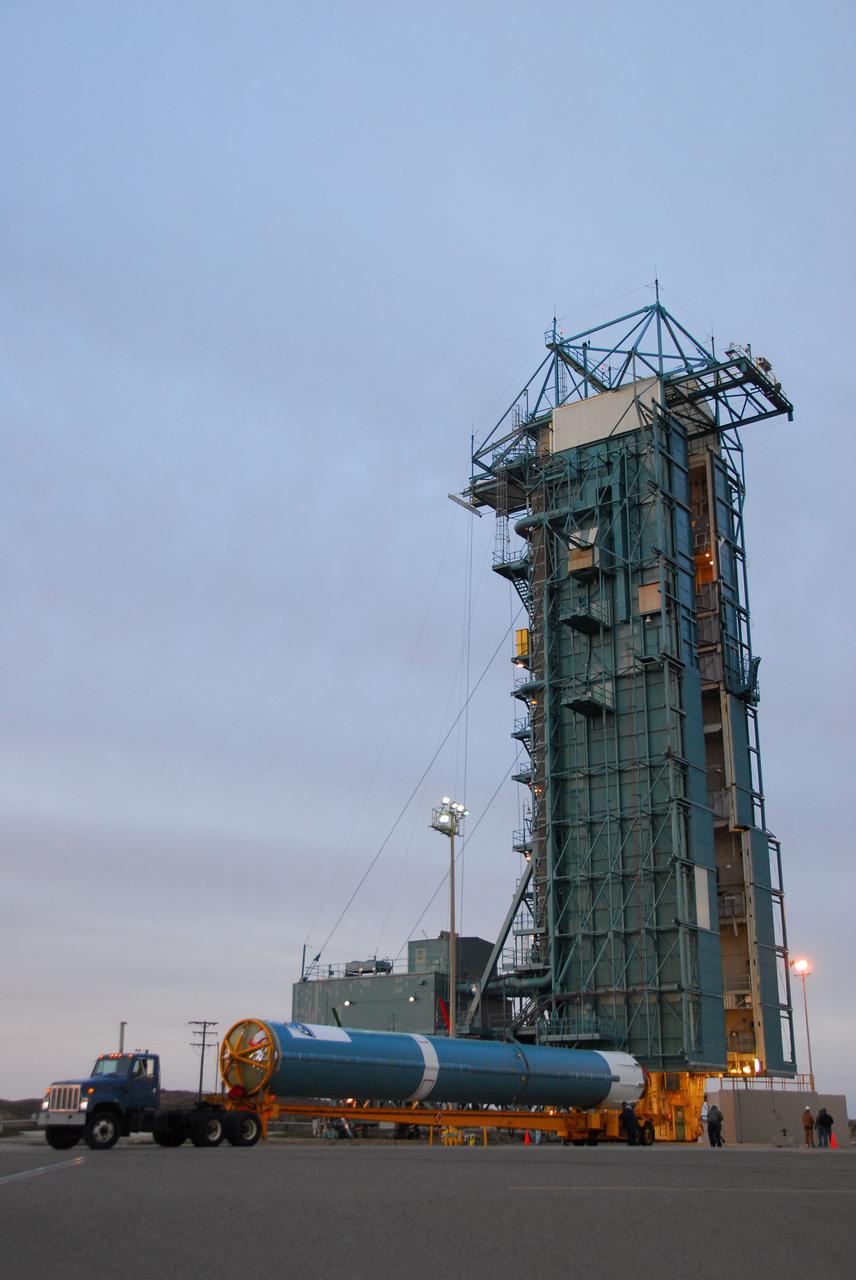 VANDENBERG AIR FORCE BASE, Calif. -- The first stage of the Delta II rocket that will carry NASA's Aquarius satellite into low Earth orbit arrives to the launch pad at Vandenberg Air Force Base's Space Launch Complex-2 (SLC-2) in California. While the Delta II rocket is stacked on SLC-2, teams for NASA's Glory spacecraft and Orbital Sciences Taurus XL rocket are in launch preparation mode at Vandenberg's nearby Space Launch Complex 576-E.      Scheduled to launch in June, Aquarius' mission will be to provide monthly maps of global changes in sea surface salinity. By measuring ocean salinity from space, Aquarius will provide new insights into how the massive natural exchange of freshwater between the ocean, atmosphere and sea ice influences ocean circulation, weather and climate. Also going up with the satellite are optical and thermal cameras, a microwave radiometer and the SAC-D spacecraft, which were developed with the help of institutions in Italy, France, Canada and Argentina. Photo credit: NASA/VAFB