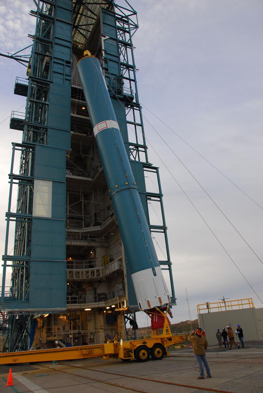 VANDENBERG AIR FORCE BASE, Calif. -- The first stage of the Delta II rocket that will carry NASA's Aquarius satellite into low Earth orbit is raised onto the launch pad at Vandenberg Air Force Base's Space Launch Complex-2 (SLC-2) in California. While the Delta II rocket is stacked on SLC-2, teams for NASA's Glory spacecraft and Orbital Sciences Taurus XL rocket are in launch preparation mode at Vandenberg's nearby Space Launch Complex 576-E.    Scheduled to launch in June, Aquarius' mission will be to provide monthly maps of global changes in sea surface salinity. By measuring ocean salinity from space, Aquarius will provide new insights into how the massive natural exchange of freshwater between the ocean, atmosphere and sea ice influences ocean circulation, weather and climate. Also going up with the satellite are optical and thermal cameras, a microwave radiometer and the SAC-D spacecraft, which were developed with the help of institutions in Italy, France, Canada and Argentina. Photo credit: NASA/VAFB