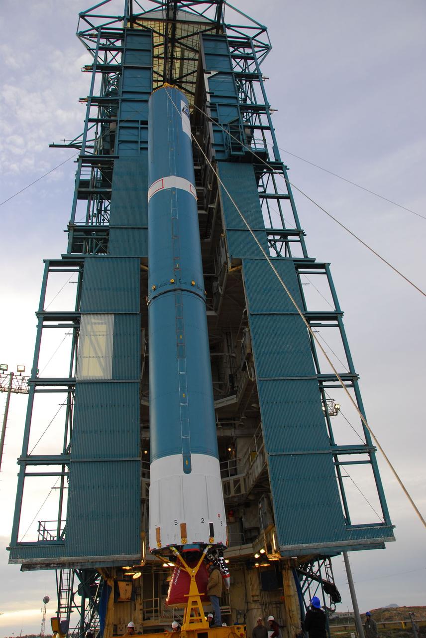 VANDENBERG AIR FORCE BASE, Calif. -- Technicians guide the first stage of the Delta II rocket that will carry NASA's Aquarius satellite into low Earth orbit onto the launch pad at Vandenberg Air Force Base's Space Launch Complex-2 (SLC-2) in California. While the Delta II rocket is stacked on SLC-2, teams for NASA's Glory spacecraft and Orbital Sciences Taurus XL rocket are in launch preparation mode at Vandenberg's nearby Space Launch Complex 576-E.      Scheduled to launch in June, Aquarius' mission will be to provide monthly maps of global changes in sea surface salinity. By measuring ocean salinity from space, Aquarius will provide new insights into how the massive natural exchange of freshwater between the ocean, atmosphere and sea ice influences ocean circulation, weather and climate. Also going up with the satellite are optical and thermal cameras, a microwave radiometer and the SAC-D spacecraft, which were developed with the help of institutions in Italy, France, Canada and Argentina. Photo credit: NASA/VAFB