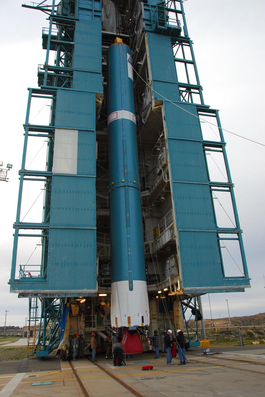 VANDENBERG AIR FORCE BASE, Calif. -- Technicians guide the first stage of the Delta II rocket that will carry NASA's Aquarius satellite into low Earth orbit onto the launch pad at Vandenberg Air Force Base's Space Launch Complex-2 (SLC-2) in California. While the Delta II rocket is stacked on SLC-2, teams for NASA's Glory spacecraft and Orbital Sciences Taurus XL rocket are in launch preparation mode at Vandenberg's nearby Space Launch Complex 576-E.        Scheduled to launch in June, Aquarius' mission will be to provide monthly maps of global changes in sea surface salinity. By measuring ocean salinity from space, Aquarius will provide new insights into how the massive natural exchange of freshwater between the ocean, atmosphere and sea ice influences ocean circulation, weather and climate. Also going up with the satellite are optical and thermal cameras, a microwave radiometer and the SAC-D spacecraft, which were developed with the help of institutions in Italy, France, Canada and Argentina. Photo credit: NASA/VAFB
