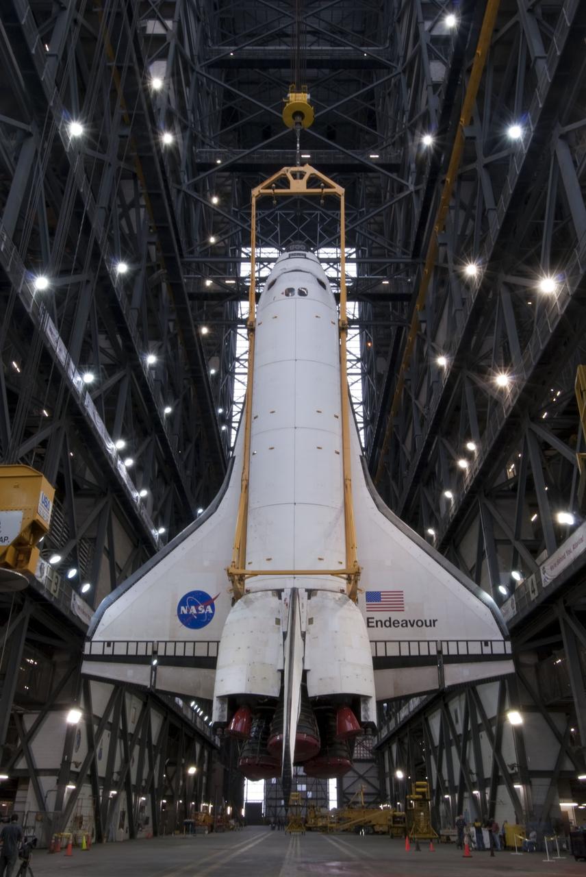 CAPE CANAVERAL, Fla. -- In the Vehicle Assembly Building at NASA's Kennedy Space Center in Florida, shuttle Endeavour is suspended above the transfer aisle. The spacecraft will be lifted and moved into a high bay where it will be attached to its external fuel tank and solid rocket boosters, already positioned on the mobile launcher platform. Endeavour and its STS-134 crew will deliver the Express Logistics Carrier-3, Alpha Magnetic Spectrometer, a high-pressure gas tank, additional spare parts for Dextre and micrometeoroid debris shields to the International Space Station. Endeavour's final launch is targeted for April 19 at 7:48 p.m. EDT. For more information visit, http://www.nasa.gov/mission_pages/shuttle/shuttlemissions/sts134/index.html. Photo credit: NASA/Jim Grossmann