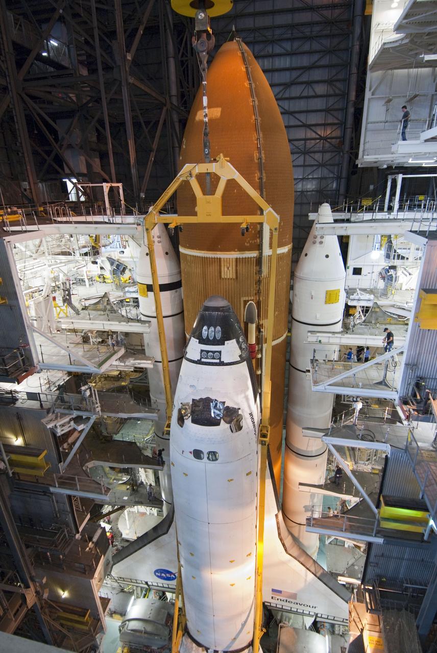 CAPE CANAVERAL, Fla. -- In the Vehicle Assembly Building at NASA's Kennedy Space Center in Florida, shuttle Endeavour is lowered into place where it will be attached to its external fuel tank and solid rocket boosters, already positioned on the mobile launcher platform. Endeavour and its STS-134 crew will deliver the Express Logistics Carrier-3, Alpha Magnetic Spectrometer, a high-pressure gas tank, additional spare parts for Dextre and micrometeoroid debris shields to the International Space Station. Endeavour's final launch is targeted for April 19 at 7:48 p.m. EDT. For more information visit, http://www.nasa.gov/mission_pages/shuttle/shuttlemissions/sts134/index.html. Photo credit: NASA/Jim Grossmann