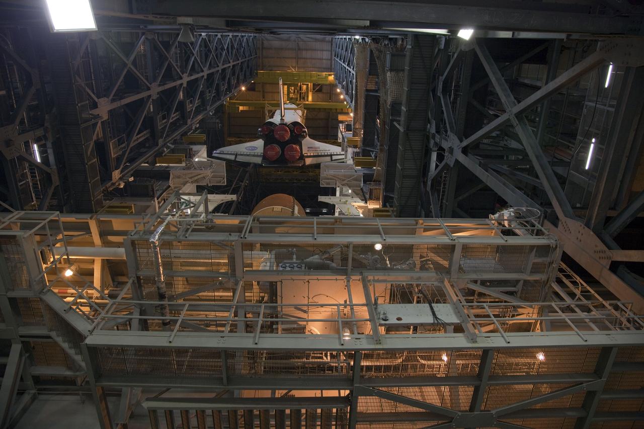 CAPE CANAVERAL, Fla. -- A large yellow, metal sling begins to lower shuttle Endeavour toward its external fuel tank and solid rocket boosters in a high bay of the Vehicle Assembly Building at NASA's Kennedy Space Center in Florida. Endeavour is targeted to roll out to Kennedy's Launch Pad 39A for its final mission, STS-134, on March 9. Endeavour and the six-member crew will deliver the Express Logistics Carrier-3, Alpha Magnetic Spectrometer-2 (AMS), a high-pressure gas tank, additional spare parts for the Dextre robotic helper and micrometeoroid debris shields to the International Space Station. Endeavour's final launch is targeted for April 19 at 7:48 p.m. EDT. For more information visit, http://www.nasa.gov/mission_pages/shuttle/shuttlemissions/sts134/index.html. Photo credit: NASA/Frankie Martin