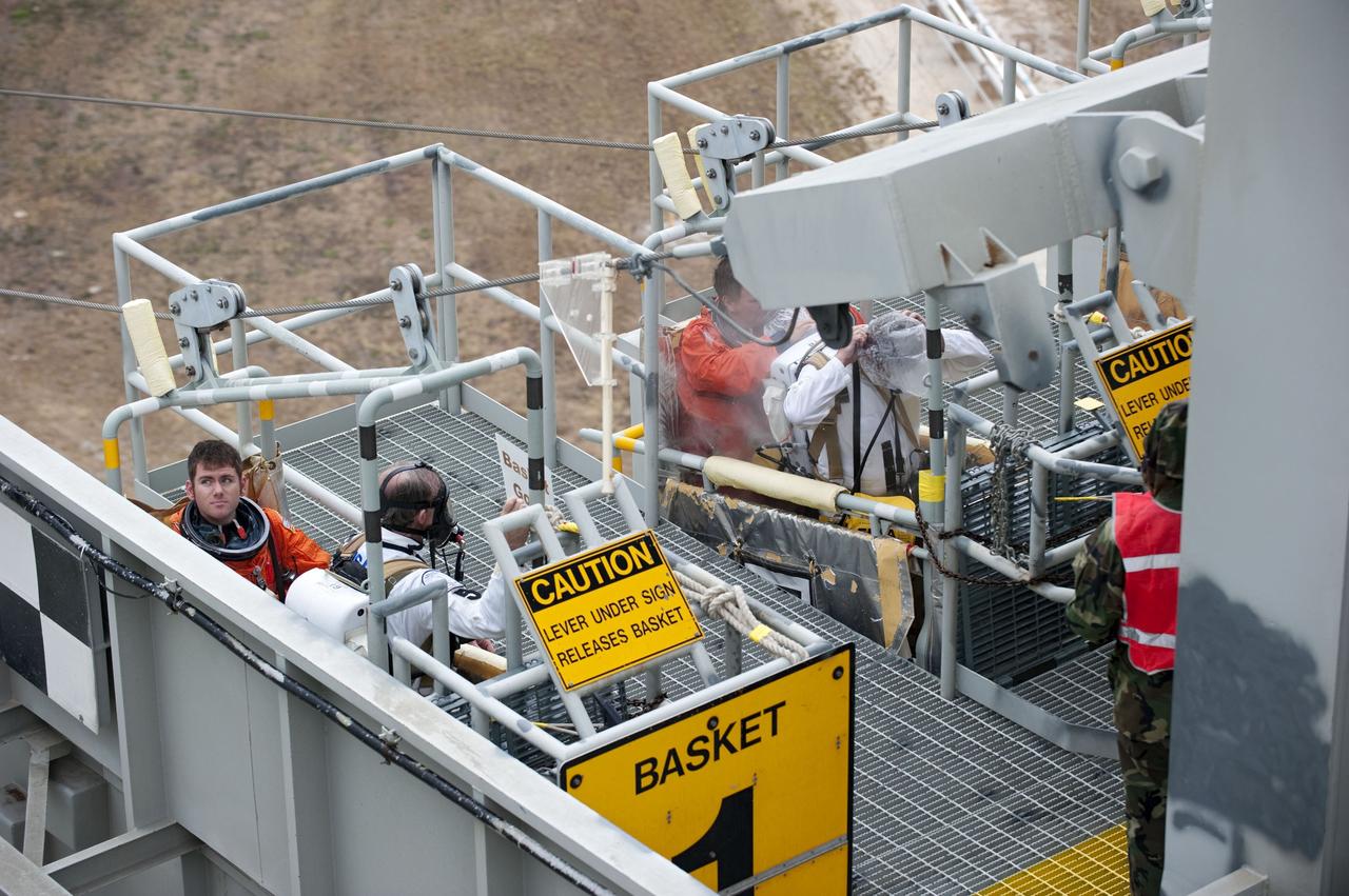 CAPE CANAVERAL, Fla. – An emergency exit, or Mode II/IV, exercise is under way at the slidewire basket area of Launch Pad 39A at NASA's Kennedy Space Center in Florida. The exercise involves NASA fire rescue personnel, volunteers portraying astronauts with simulated injuries, helicopters and personnel from the Air Force’s 920th Rescue Wing, and medical trauma teams at three Central Florida hospitals. The drill allows teams to practice an emergency response at the launch pad, including helicopter evacuation to local hospitals.                   Photo credit: NASA/Kim Shiflett