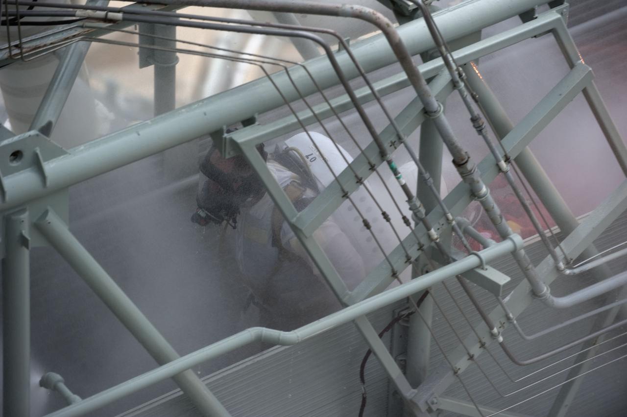 CAPE CANAVERAL, Fla. – An emergency exit, or Mode II/IV, exercise is under way at the 195-foot level of Launch Pad 39A at NASA's Kennedy Space Center in Florida. The exercise involves NASA fire rescue personnel, volunteers portraying astronauts with simulated injuries, helicopters and personnel from the Air Force’s 920th Rescue Wing, and medical trauma teams at three Central Florida hospitals. The drill allows teams to practice an emergency response at the launch pad, including helicopter evacuation to local hospitals.             Photo credit: NASA/Kim Shiflett