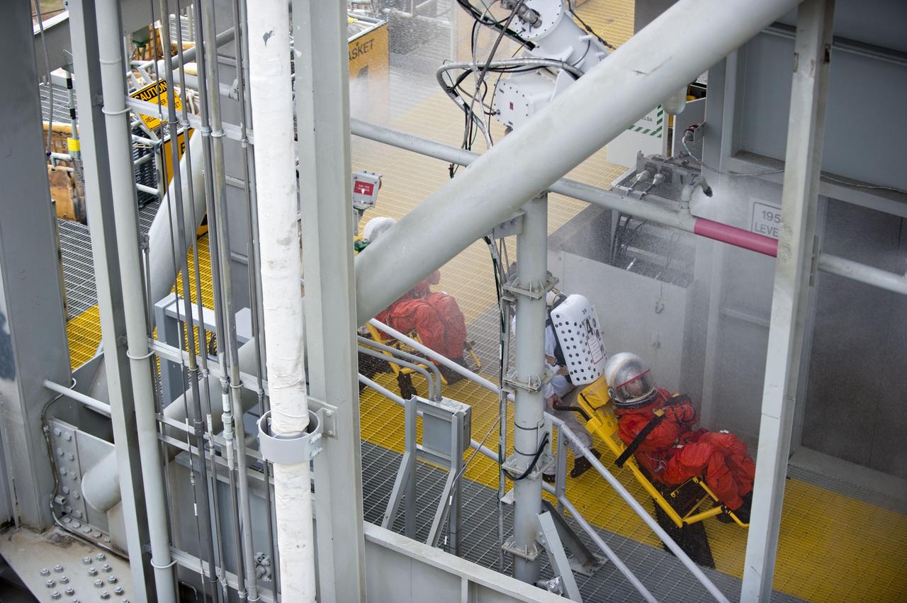 CAPE CANAVERAL, Fla. – An emergency exit, or Mode II/IV, exercise is under way at the 195-foot level of Launch Pad 39A at NASA's Kennedy Space Center in Florida. The exercise involves NASA fire rescue personnel, volunteers portraying astronauts with simulated injuries, helicopters and personnel from the Air Force’s 920th Rescue Wing, and medical trauma teams at three Central Florida hospitals. The drill allows teams to practice an emergency response at the launch pad, including helicopter evacuation to local hospitals.           Photo credit: NASA/Kim Shiflett