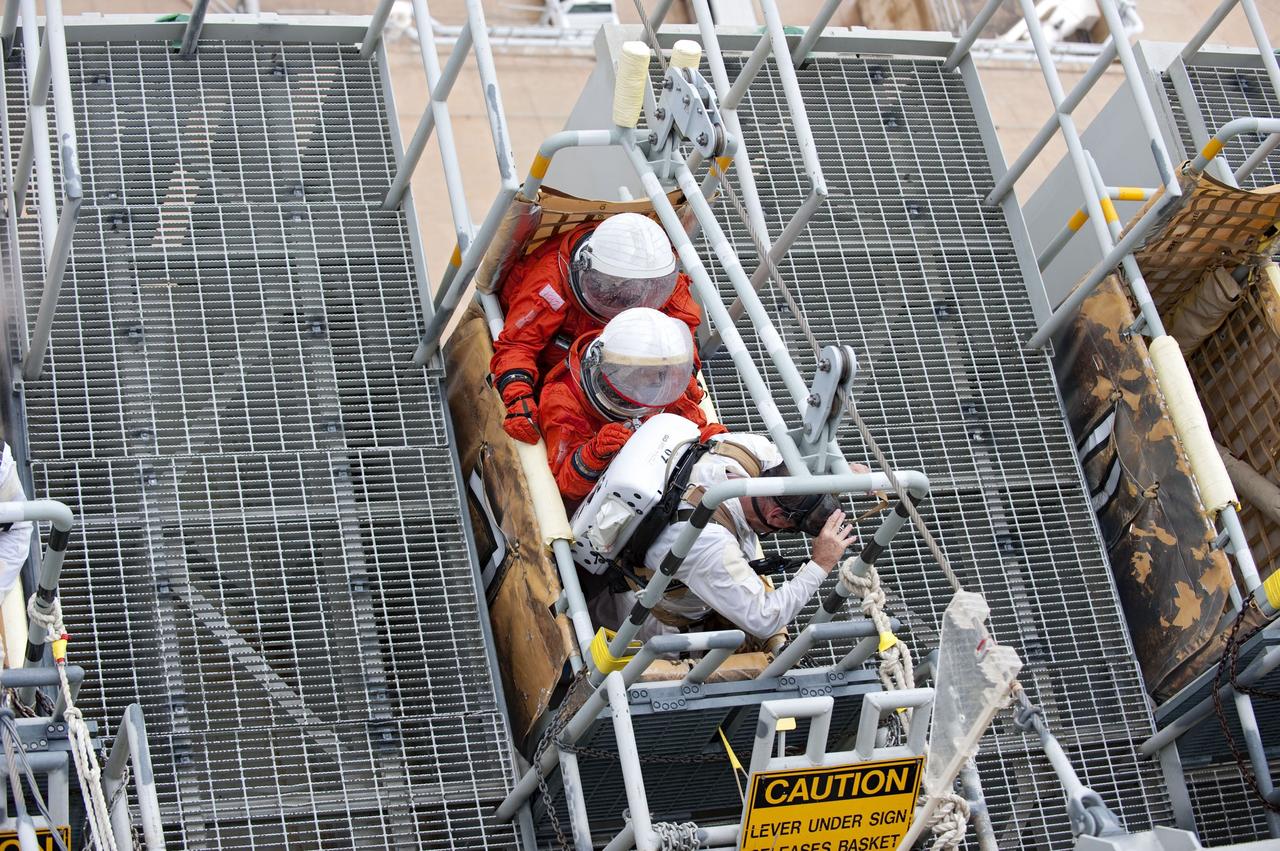 CAPE CANAVERAL, Fla. – An emergency exit, or Mode II/IV, exercise is under way at the slidewire basket area of Launch Pad 39A at NASA's Kennedy Space Center in Florida. The exercise involves NASA fire rescue personnel, volunteers portraying astronauts with simulated injuries, helicopters and personnel from the Air Force’s 920th Rescue Wing, and medical trauma teams at three Central Florida hospitals. The drill allows teams to practice an emergency response at the launch pad, including helicopter evacuation to local hospitals.         Photo credit: NASA/Kim Shiflett