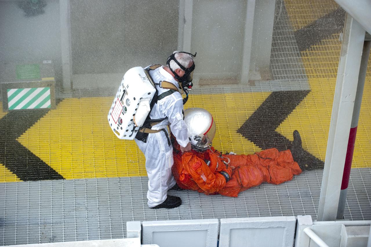 CAPE CANAVERAL, Fla. – An emergency exit, or Mode II/IV, exercise is under way at the 195-foot level of Launch Pad 39A at NASA's Kennedy Space Center in Florida. The exercise involves NASA fire rescue personnel, volunteers portraying astronauts with simulated injuries, helicopters and personnel from the Air Force’s 920th Rescue Wing, and medical trauma teams at three Central Florida hospitals. The drill allows teams to practice an emergency response at the launch pad, including helicopter evacuation to local hospitals.               Photo credit: NASA/Kim Shiflett