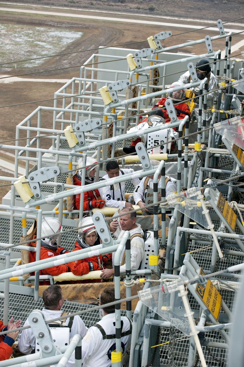 CAPE CANAVERAL, Fla. – An emergency exit, or Mode II/IV, exercise is under way at the slidewire basket area of Launch Pad 39A at NASA's Kennedy Space Center in Florida. The exercise involves NASA fire rescue personnel, volunteers portraying astronauts with simulated injuries, helicopters and personnel from the Air Force’s 920th Rescue Wing, and medical trauma teams at three Central Florida hospitals. The drill allows teams to practice an emergency response at the launch pad, including helicopter evacuation to local hospitals.     Photo credit: NASA/Kim Shiflett