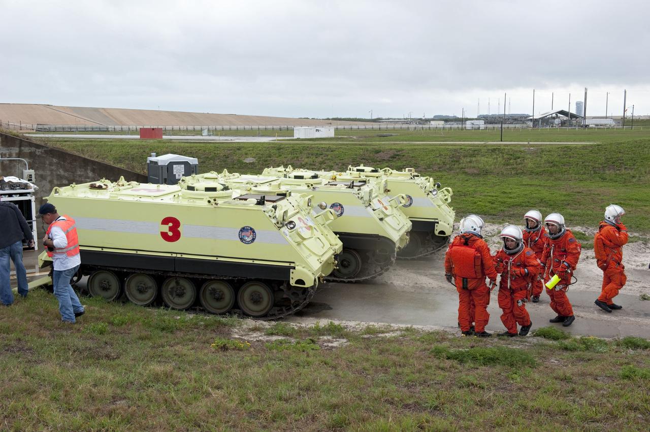 CAPE CANAVERAL, Fla. – On Launch Pad 39A at NASA's Kennedy Space Center in Florida, an emergency exit, or Mode II/IV, exercise is under way. Seen here are M-113 armored personnel carriers near the slidewire basked landing site. The exercise involves NASA fire rescue personnel, volunteers portraying astronauts with simulated injuries, helicopters and personnel from the Air Force’s 920th Rescue Wing, and medical trauma teams at three Central Florida hospitals. The drill allows teams to practice an emergency response at the launch pad, including helicopter evacuation to local hospitals.               Photo credit: NASA/Kim Shiflett