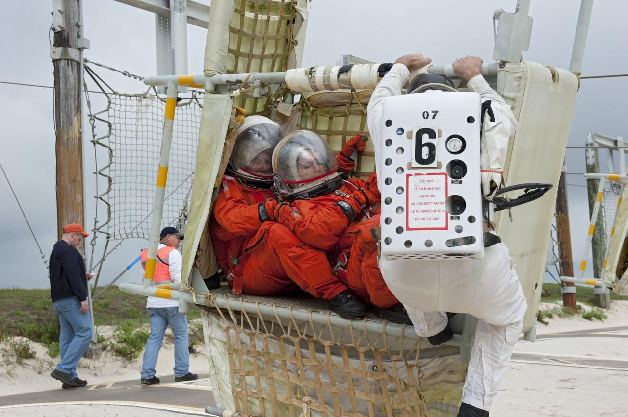CAPE CANAVERAL, Fla. – An emergency exit, or Mode II/IV, exercise is under way at the slidewire basket landing site of Launch Pad 39A at NASA's Kennedy Space Center in Florida. The exercise involves NASA fire rescue personnel, volunteers portraying astronauts with simulated injuries, helicopters and personnel from the Air Force’s 920th Rescue Wing, and medical trauma teams at three Central Florida hospitals. The drill allows teams to practice an emergency response at the launch pad, including helicopter evacuation to local hospitals.           Photo credit: NASA/Kim Shiflett